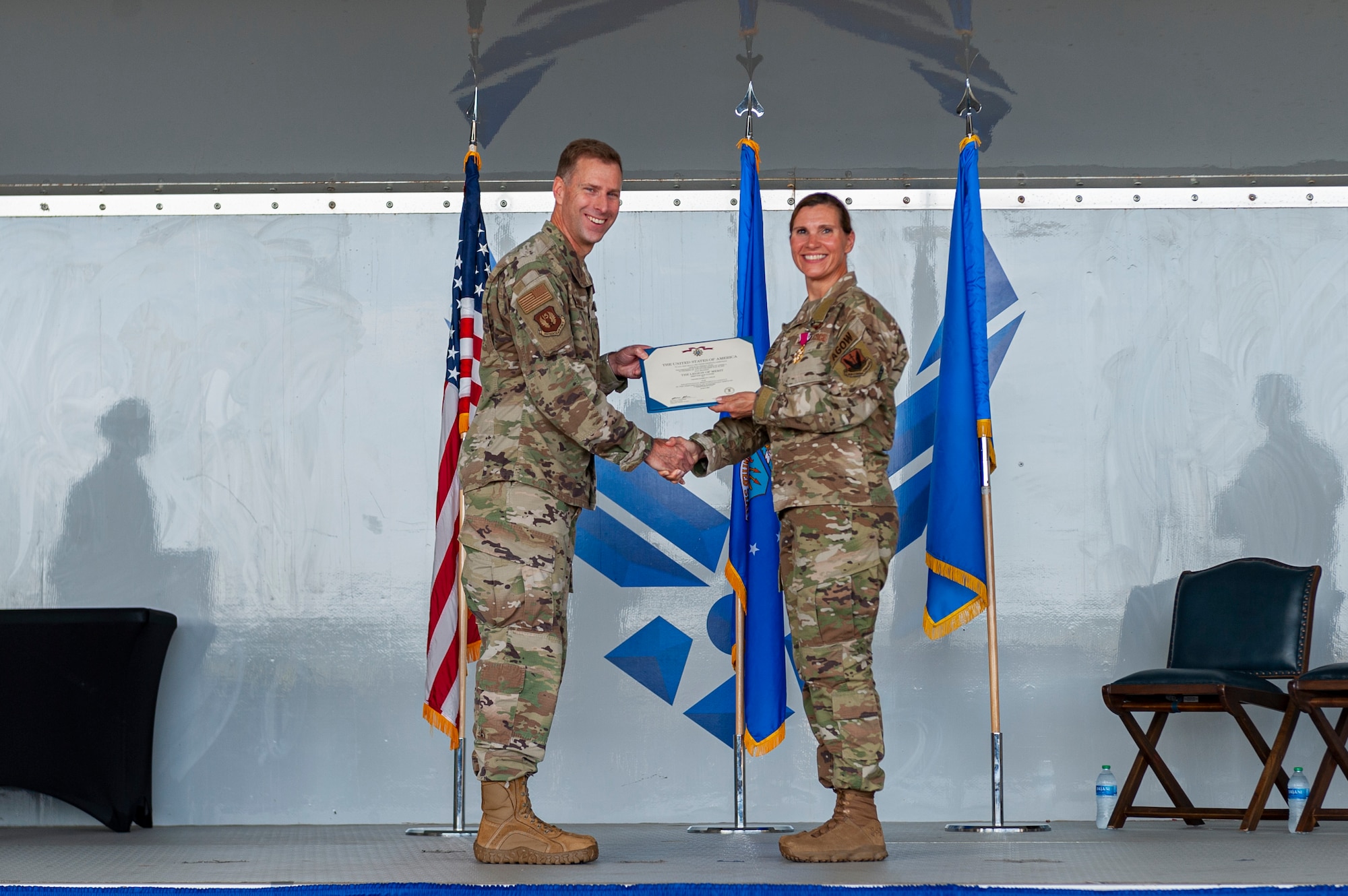 Photo of an Airmen receiving a meritorious service medal