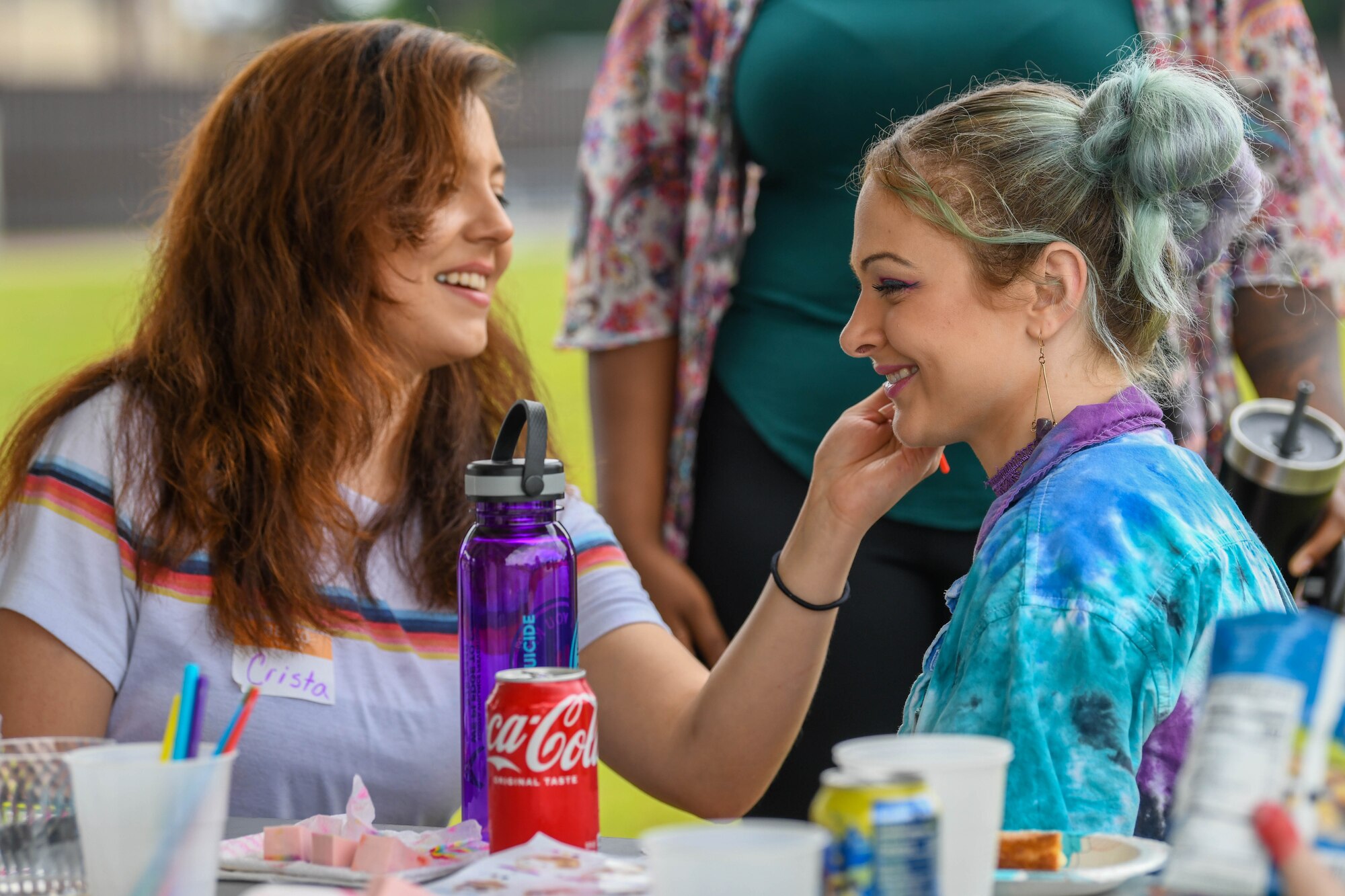 A volunteer paints a participant’s face