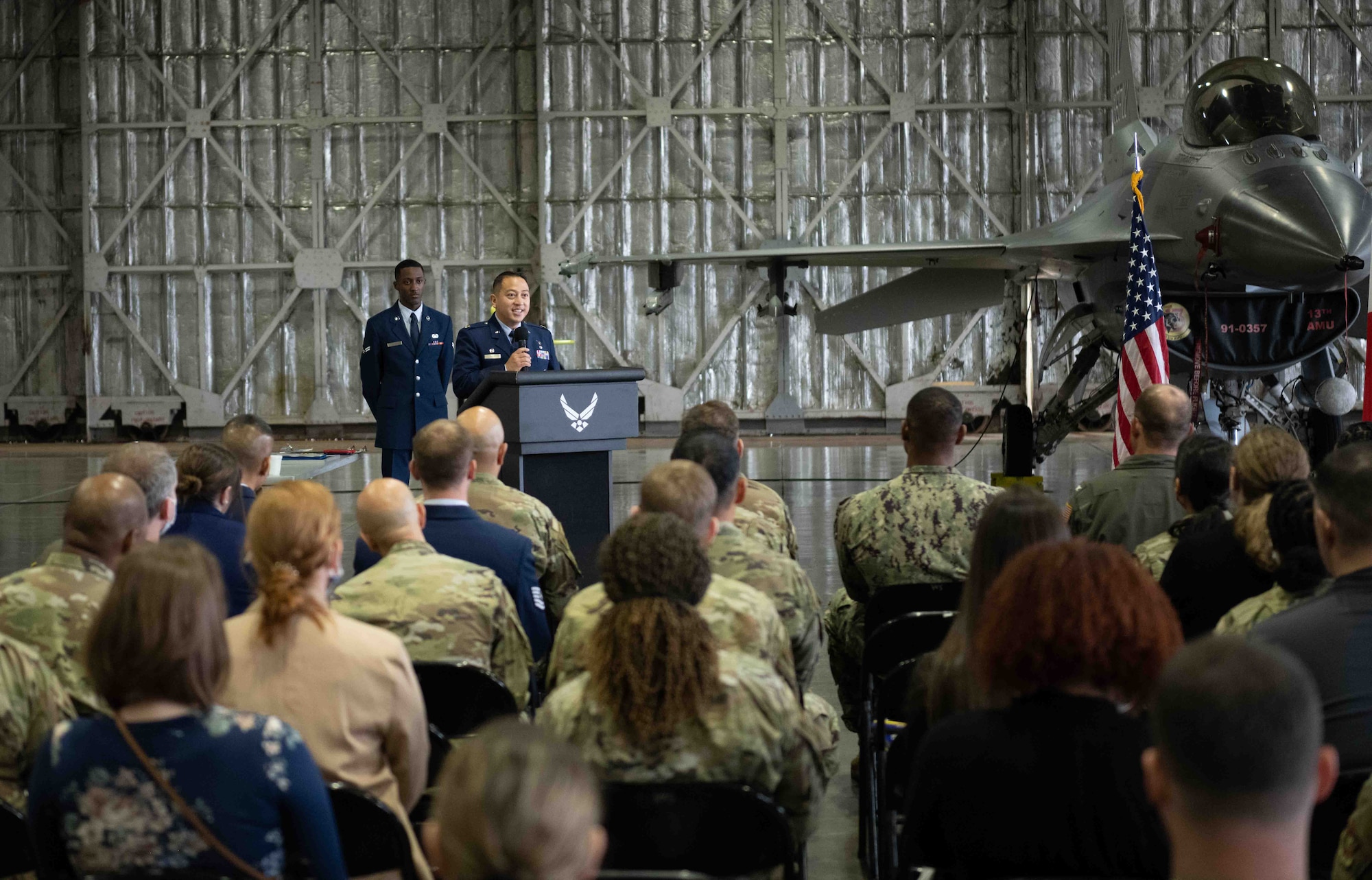 A military member gives remarks to an audience.