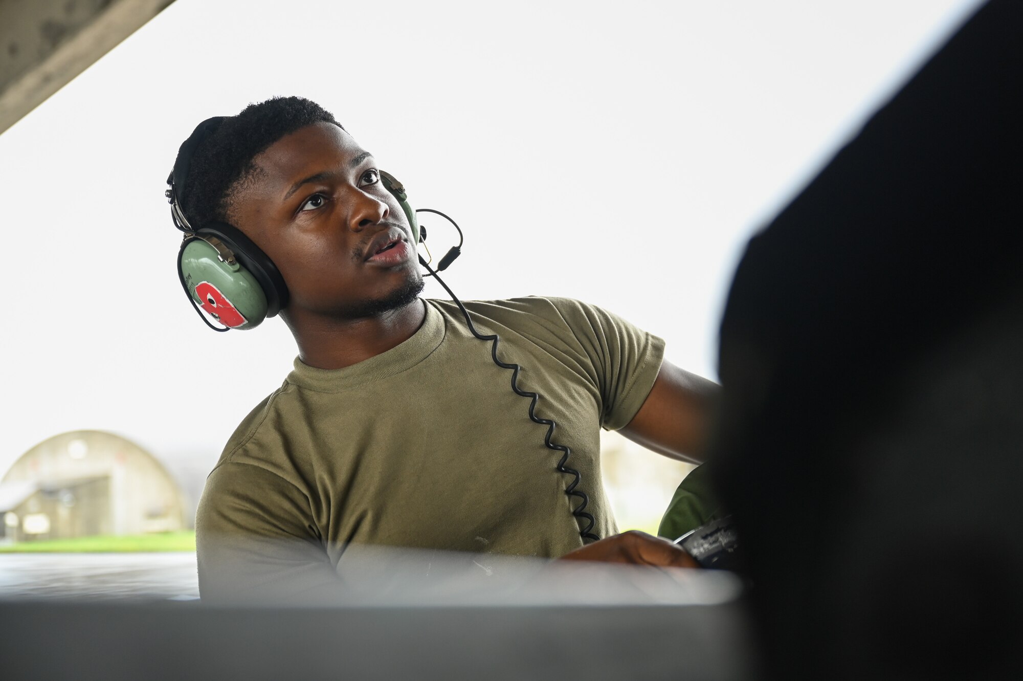 Photo of a U.S. Airman conducting a pre-flight check.