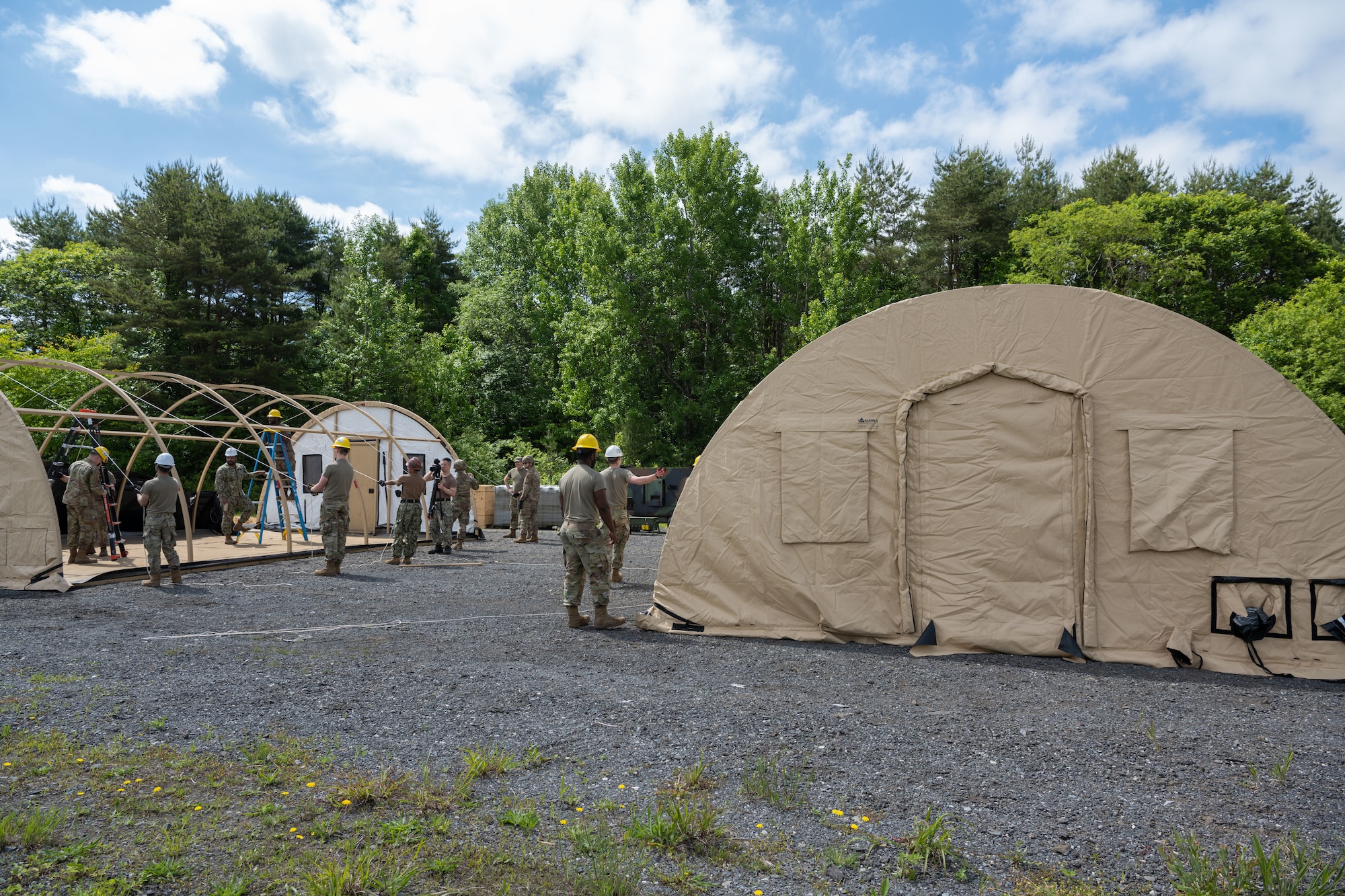 U.S. Airmen assigned to the 35th Civil Engineer Squadron (CES) assemble Disaster Relief Beddown System tents during the annual Prime Base Engineer Emergency Force (Prime BEEF) training at Misawa Air Base, Japan, June 14, 2022.