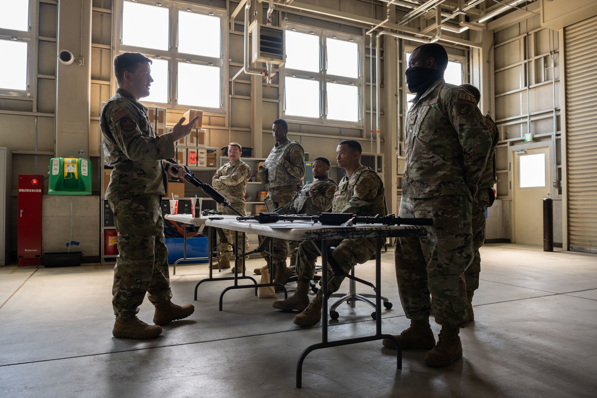 U.S. Air Force Staff Sgt. Woodrow Young, 35th Civil Engineer Squadron structural craftsman, explains safety features while teaching weapons familiarization during the annual Prime Base Engineer Emergency Force (Prime BEEF) training at Misawa Air Base, Japan, June 14, 2022.
