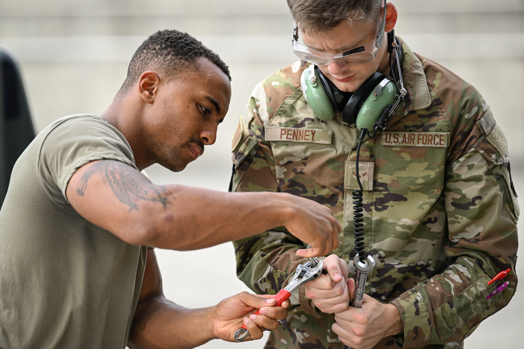 Photo of airmen conducting pre-flight checks.