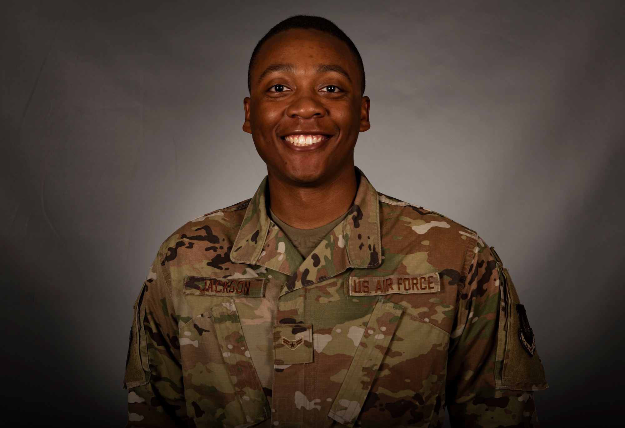 Airman smiles in studio portrait
