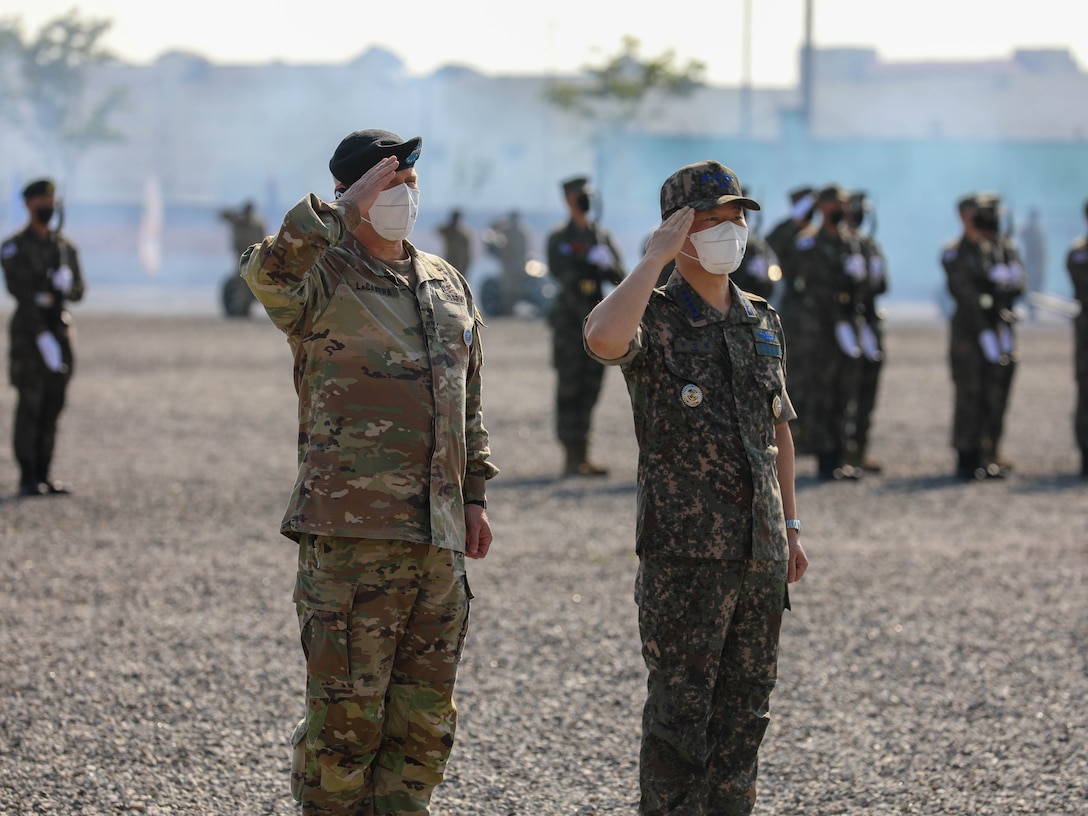 Gen. Won In-choul and Gen. Paul J. LaCamera salute the colors during a farewell ceremony at Barker Field on U.S. Army Garrison Humphreys.