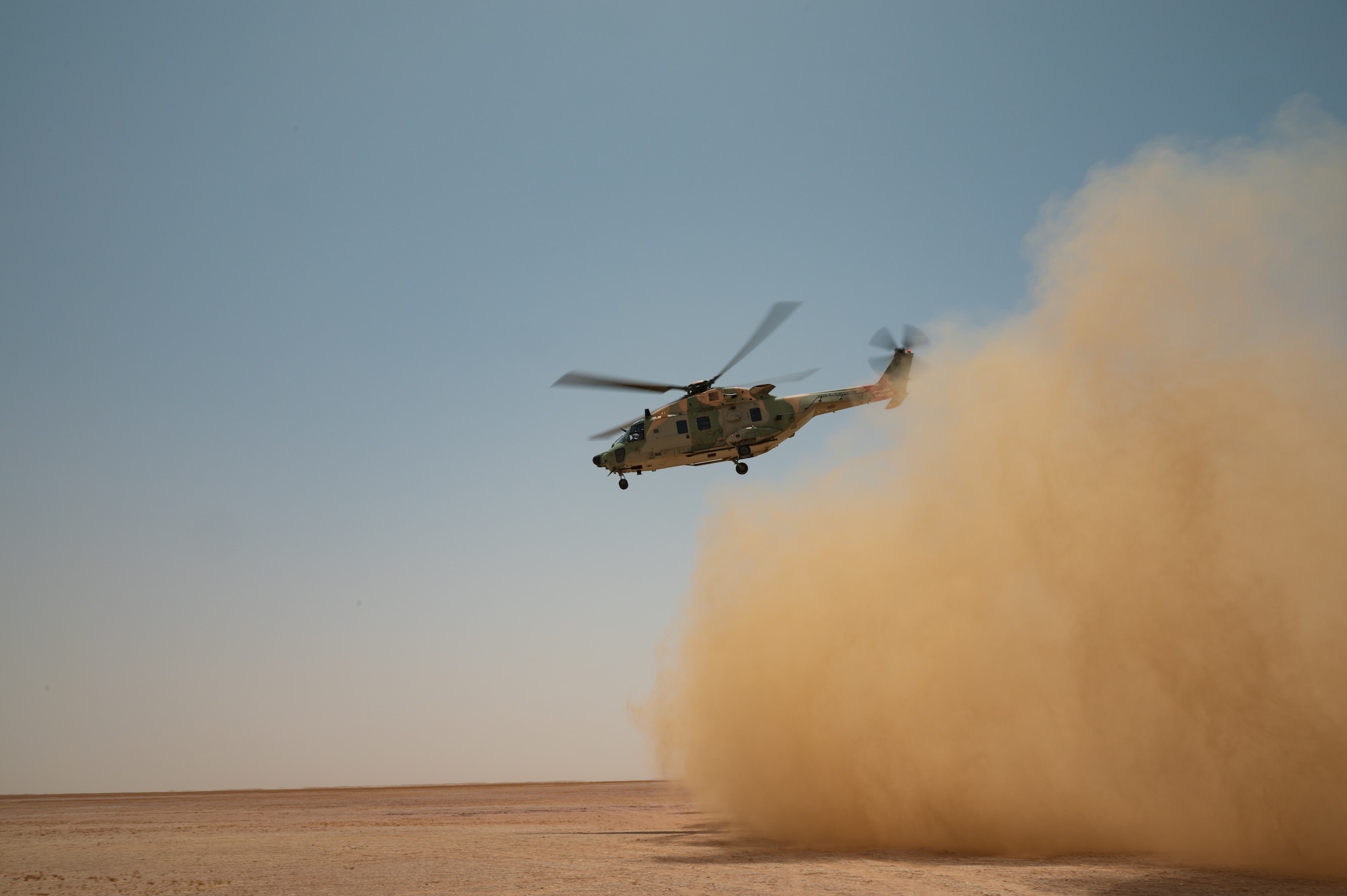 A Royal Air Force of Oman helicopter lifts off from the desert in Oman during a Survival Evasion Resistance and Escape training exercise for Accurate Test 22, May 17, 2022. The RAFO helicopter crew loaded a patient during a simulated combat search and rescue operation and airlifted the patient to the nearest medical facility. (U.S. Air Force photo by Staff Sgt. Dana Tourtellotte)