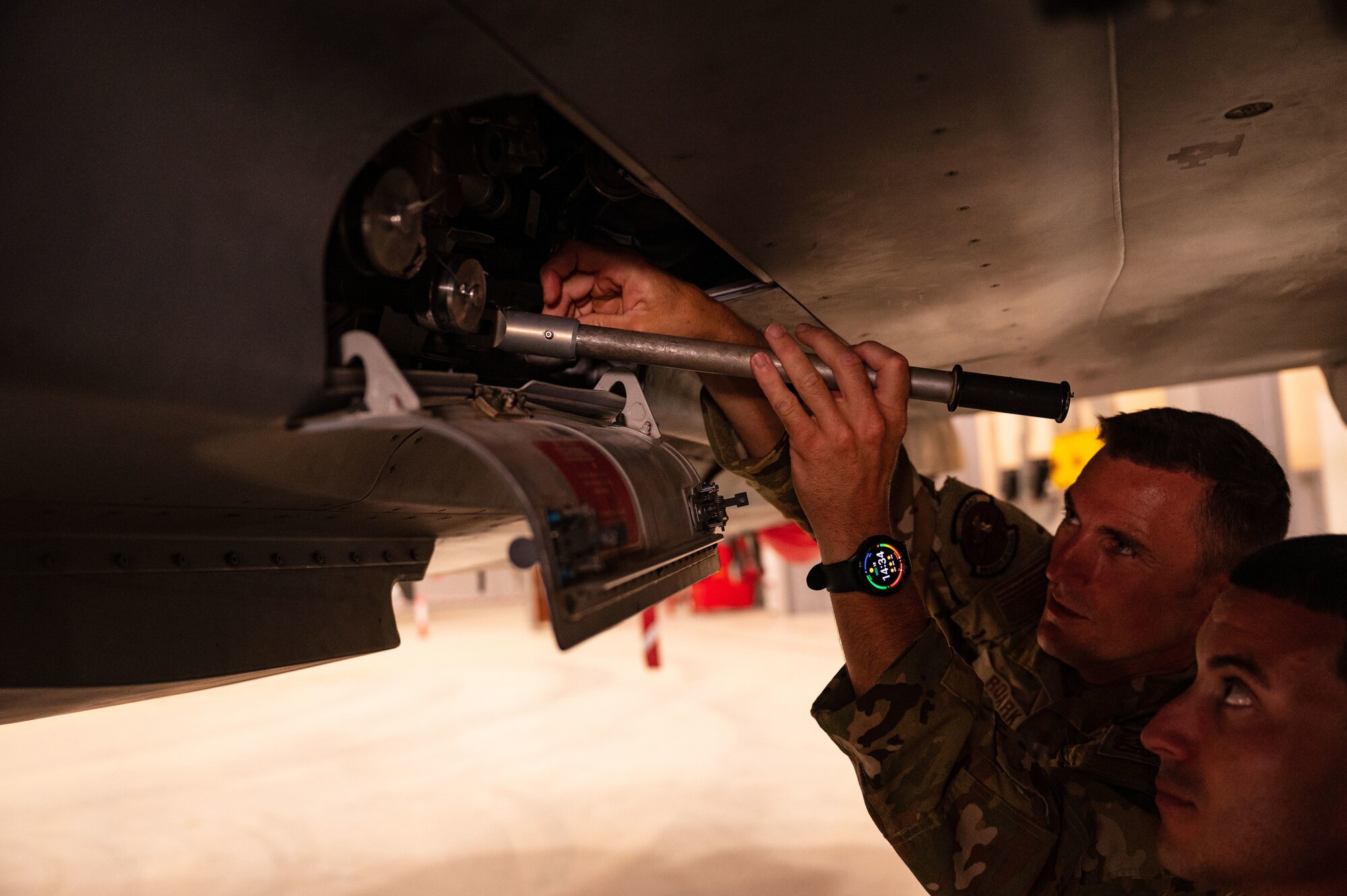 U.S. Air Force firefighters from the 379th Air Expeditionary Wing inspect a component of a safety system on a Royal Air Force of Oman Eurofighter Typhoon aircraft at Thumrait Air Base, Oman, May 18, 2022. The RAFO fire chief showed the U.S. Airmen the fire safety measures that exist throughout the aircraft and gave them opportunities to use many of the features on the aircraft. (U.S. Air Force photo by Staff Sgt. Dana Tourtellotte)