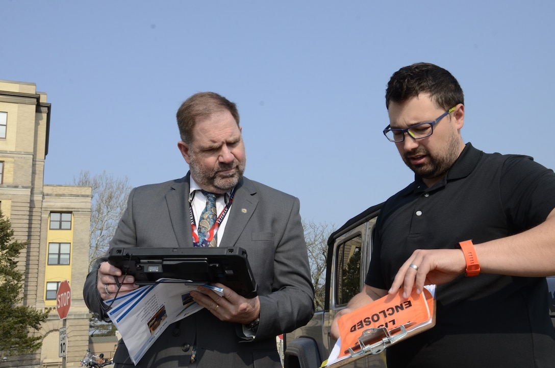 two men use a tablet