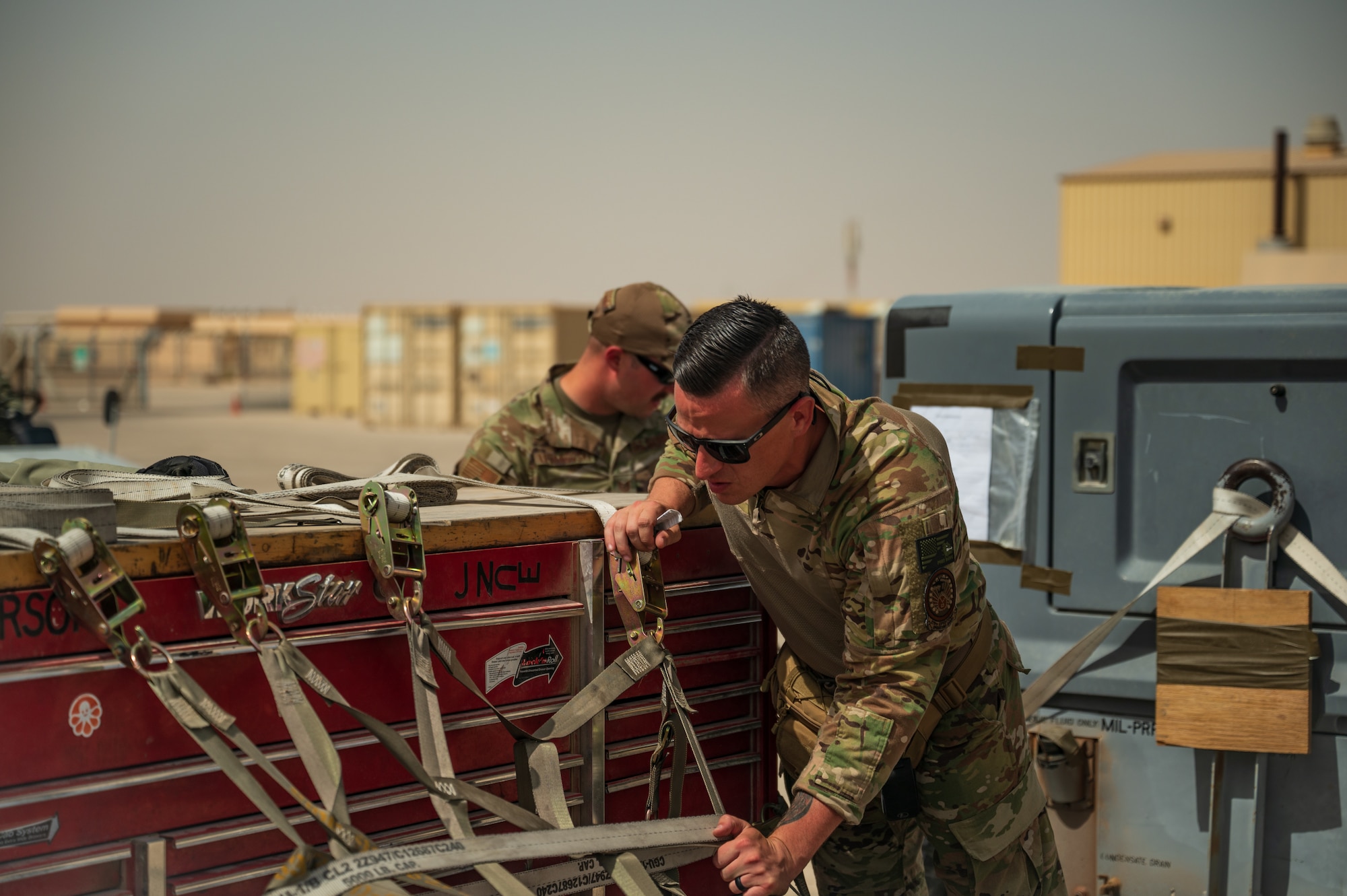 U.S. Air Force Tech Sgt. Cory Tracy, forward deployed from the 387th Air Expeditionary Squadron, Ali Al Salem Air Base, Kuwait, inspects cargo in preparation for a departure flight during Accurate Test 22 at Thumrait Air Base, Oman, May 22, 2022. The inspection helped ensure that the cargo was safe, secure and properly marked for shipment. (U.S. Air Force photo by Staff Sgt. Dana Tourtellotte)