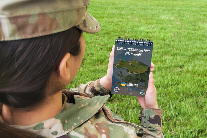 Female U.S Airman holding an Expeditionary Culture Field Guide