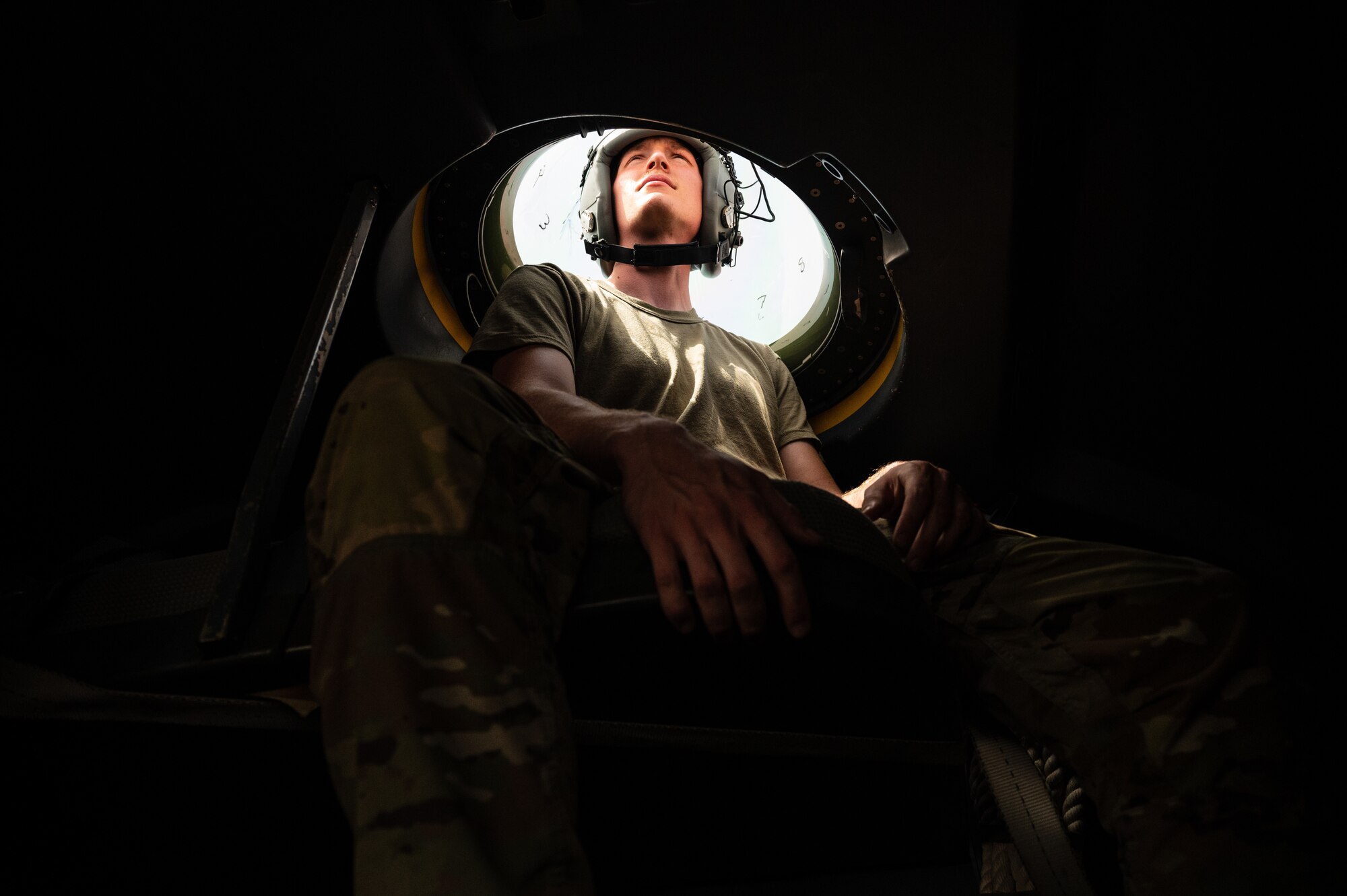 A U.S. Air Force C-130 maintenance member, assigned to the 41st Expeditionary Airlift Squadron, watches a combat formation exercise through a cupola window atop a U.S. C-130J Super Hercules aircraft during Accurate Test 22, May 19, 2022. This exercise took place alongside a Royal Air Force of Oman C-130 aircraft and simulated a low altitude pursuit over the open desert near Thumrait Air Base, Oman. (U.S. Air Force photo by Staff Sgt. Dana Tourtellotte)