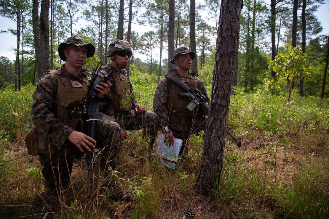 U.S. Marine Corps Cpl. Parker Haynes, left, Sgt. Uvaldo Tapia and Cpl. Ricardo Morales, right, Combat Skills Program participants (CSP), conduct radio calls on Camp Devil Dog in Jacksonville, North Carolina, June 8, 2022.