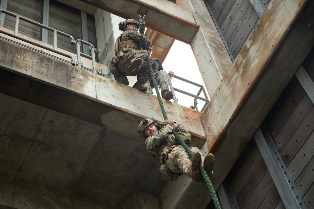 U.S. Marine Corps Sgt. Joey Lupardus, an explosive ordnance disposal technician, top, with Explosive Ordnance Disposal Company, 9th Engineer Support Battalion, 3rd Marine Logistics Group, and U.S. Air Force Tech. Sgt. Zackary Thorington, bottom, with the 99th Civil Engineer Squadron Explosive Ordnance Disposal Team, conduct a speed stick drill during a mission rehearsal on Camp Schwab, Okinawa, Japan, June 15, 2022. 3rd MLG, based out of Okinawa, Japan, is a forward deployed combat unit that serves as III Marine Expeditionary Force's comprehensive logistics and combat service support backbone for operations throughout the Indo-Pacific area of responsibility.