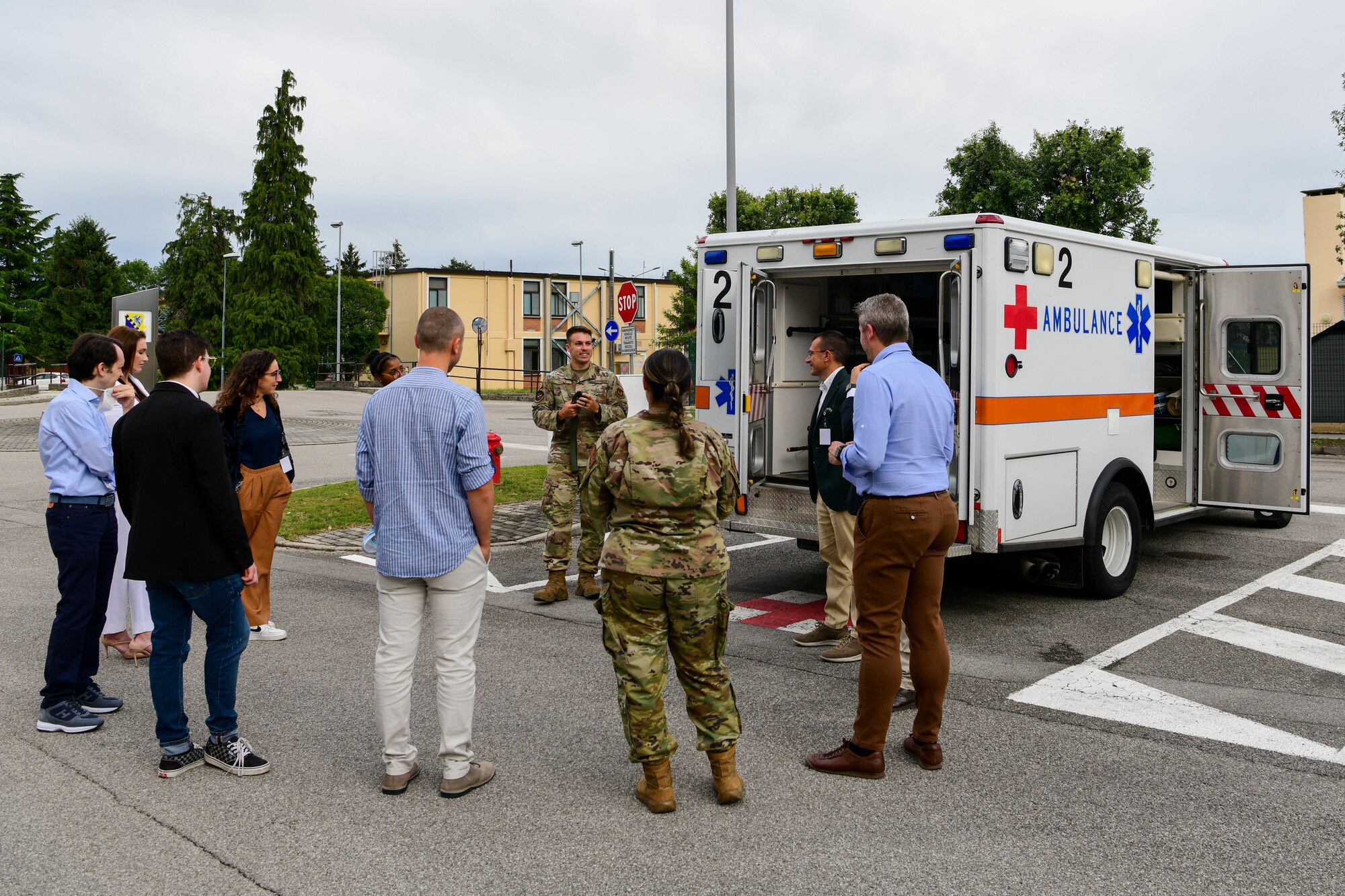 A U.S. Air Force Airman assigned to the 31st Medical Group briefs Italian host nation providers on 31st MDG ambulance services operations at a 31st MDG Open House event at Aviano Air Bae, Italy, June 9, 2022. The host nation providers toured five locations which included the 31st MDG laboratory, pharmacy, Education and Training simulation laboratory, family health primary care clinics and ambulance services. (U.S. Air Force photo by Senior Airman Brooke Moeder)