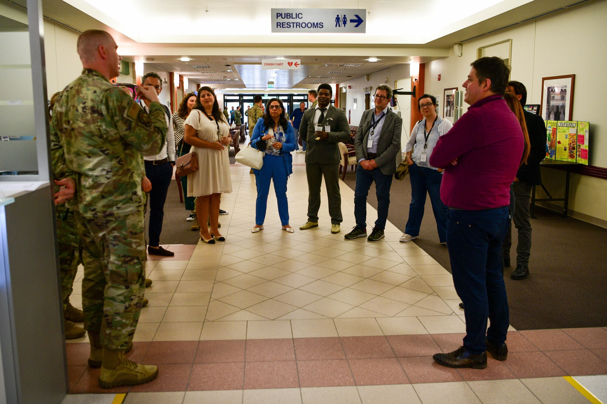 A U.S. Air Force Airman assigned to the 31st Medical Group, left, briefs Italian host nation healthcare and network providers on the 31st MDG family health primary care clinic operations during an Open House at Aviano Air Base, Italy, June 9, 2022. The 31st MDG hosted an Open House event to foster new relationships and strengthen bonds previously formed with local Italian healthcare facilities and network providers. (U.S. Air Force photo by Senior Airman Brooke Moeder)