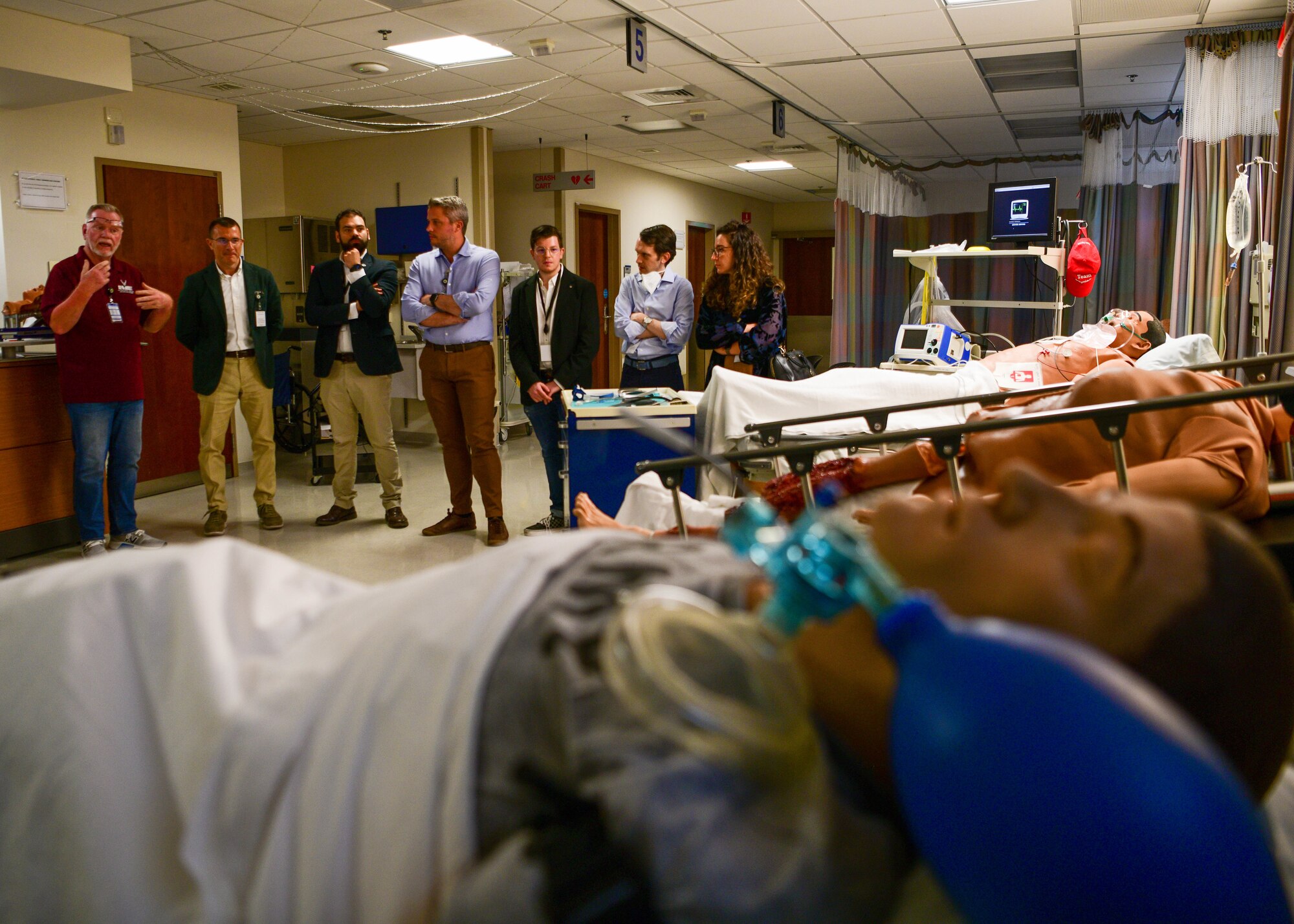 Gene Bryan, 31st Medical Group Education and Training medical simulation operator, left, briefs Italian host nation providers on 31st MDG Education and Training simulation laboratory operations during a 31st MDG Open House event at Aviano Air Base, Italy, June 9, 2022. The host nation providers toured five locations which included the 31st MDG laboratory, pharmacy, Education and Training simulation laboratory, family health primary care clinics and ambulance services. (U.S. Air Force photo by Senior Airman Brooke Moeder)