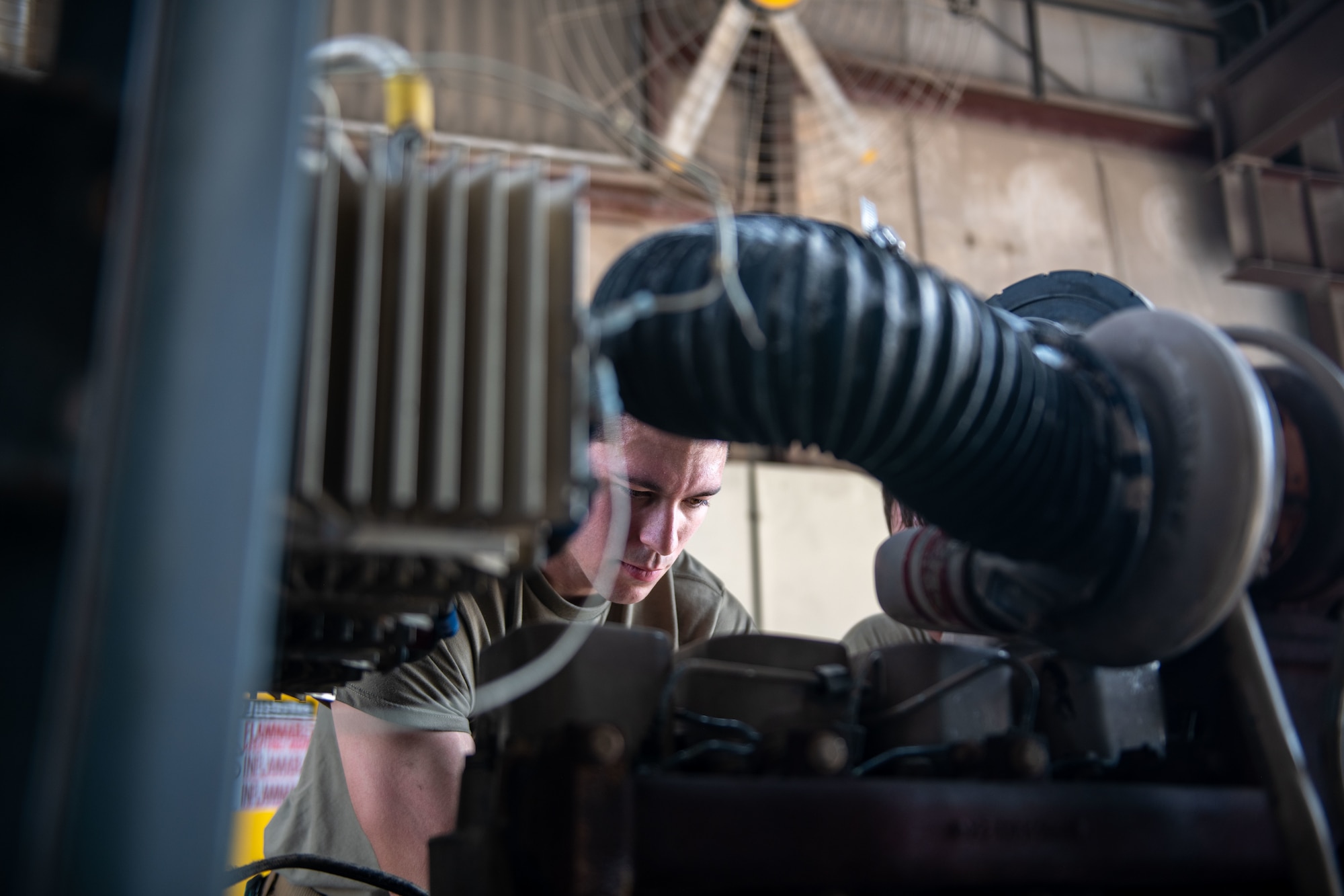 U.S. Air Force Staff Sgt. Jason Szurlej, an Aerospace Ground Equipment Specialist, loosens bolts on a generator engine on Al Udeid Air Base, Qatar, June 9, 2022. Maintainers are responsible for the preserving the longevity of different machinery and equipment. (U.S. Air National Guard photo by Airman 1st Class Constantine Bambakidis)