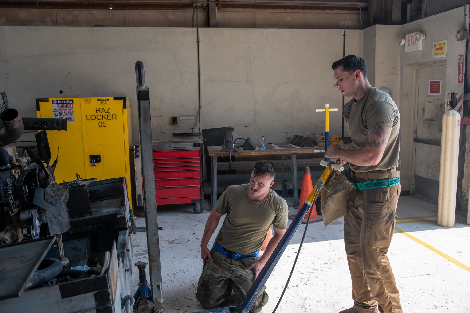 U.S. Air Force Airman 1st Class Cameron Waters and U.S. Air Force Staff Sgt. Jason Szurlej, 379th Air Expeditionary Wing Aerospace Ground Equipment Specialists, place a generator motor on jack stands on Al Udeid Air Base, Qatar, June 9, 2022. Maintenance of equipment helps to ensure its reliability on the flight line. (U.S. Air National Guard photo by Airman 1st Class Constantine Bambakidis)