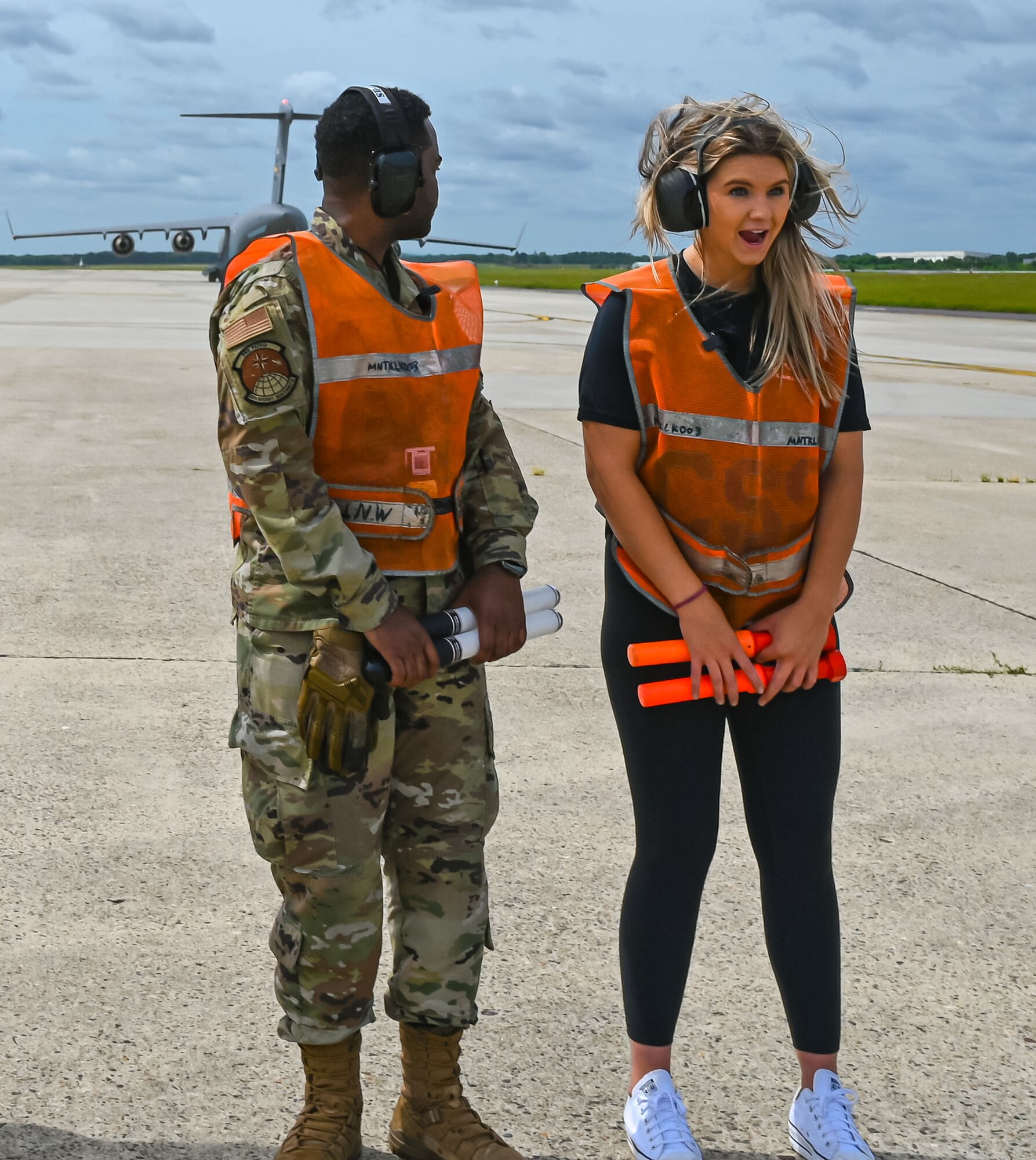 Formula Drift driver Amanda Sorenson expresses her excitement upon feeling the jet blast of a C-17 Globemaster III during a marshaling demo at Joint Base McGuire-Dix-Lakehurst on June 7, 2022. Drift team duo Branden and Amanda Sorensen visited JB MDL to interact with Airmen and learn about different Air Force career fields. Air Force Recruiting Service recently continued their 13-year partnership with the Formula Drift series. Throughout the 2022 Formula Drift circuit, the Air Force will serve as the primary sponsor for the Sorensen Motorsports team.