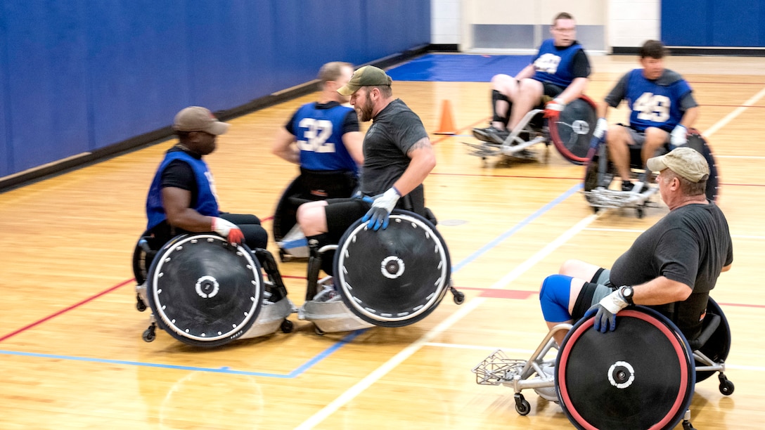 One athlete slams his chair into another near the goal line during wheelchair rugby practice.