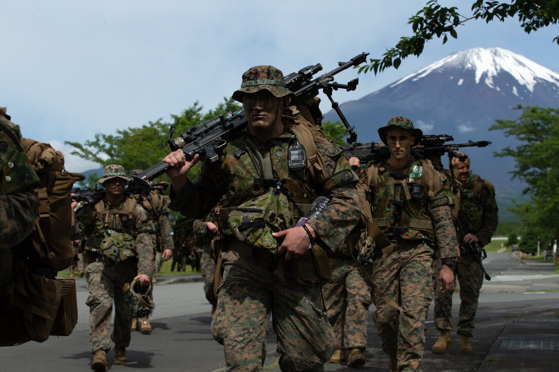 U.S. Marines with 3d Battalion, 2d Marines, prepare to begin Exercise Shinka 22.1 at the Combined Arms Training Center, Camp Fuji, Japan, June 13, 2022. Shinka exemplifies a shared commitment to realistic training that produces lethal, ready, and adaptable forces capable of decentralized operations across a wide range of missions. 3/2 is forward deployed in the Indo-Pacific under 4th Marines, 3d Marine Division as part of the Unit Deployment Program. (U.S. Marine Corps photo by Lance Cpl. Michael Taggart)