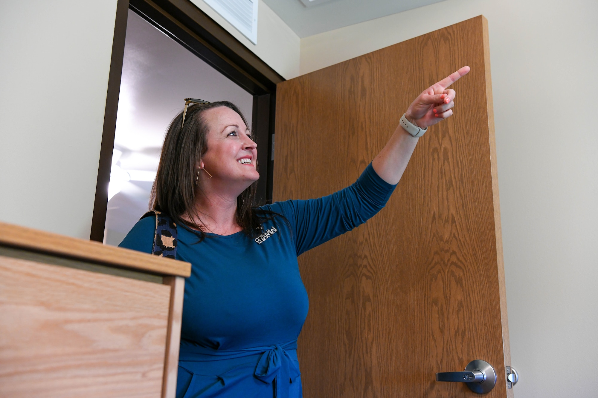 Jennifer Baker, 97th Air Mobility Wing key spouse, admires one of the bedrooms in the new dormitory at Altus Air Force Base, Oklahoma, June 13, 2022. Each individual room in the dormitory features a walk-in closet and bathroom. (U.S. Air Force photo by Airman 1st Class Trenton Jancze)