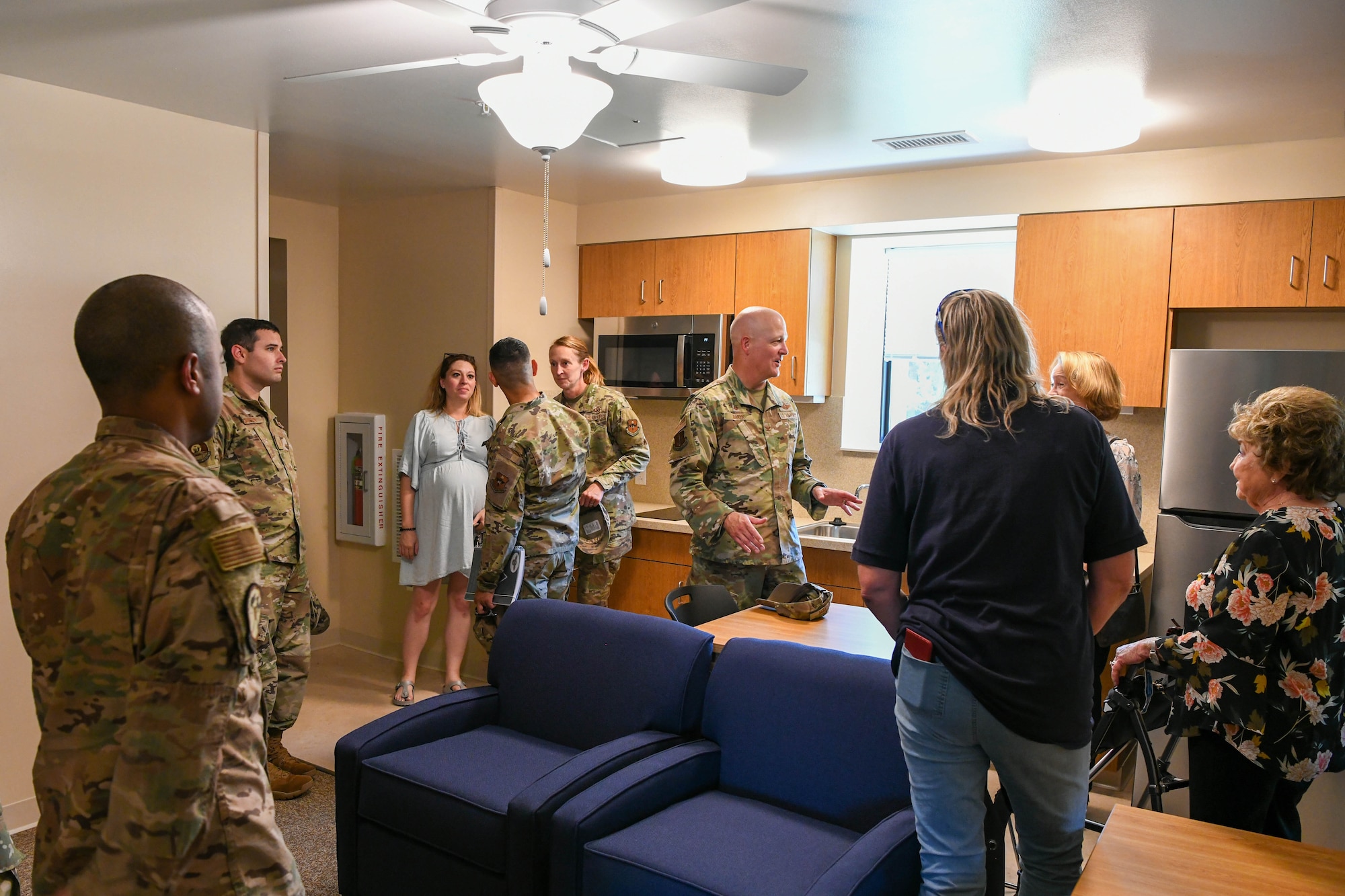 Airmen and members of the Altus Air Force Base, Oklahoma, community explore the newest dormitory on base, June 13, 2022. Residents of each suite will share a common area furnished with couches, a TV, dining space, laundry appliances, and a kitchenette. (U.S. Air Force photo by Airman 1st Class Trenton Jancze)