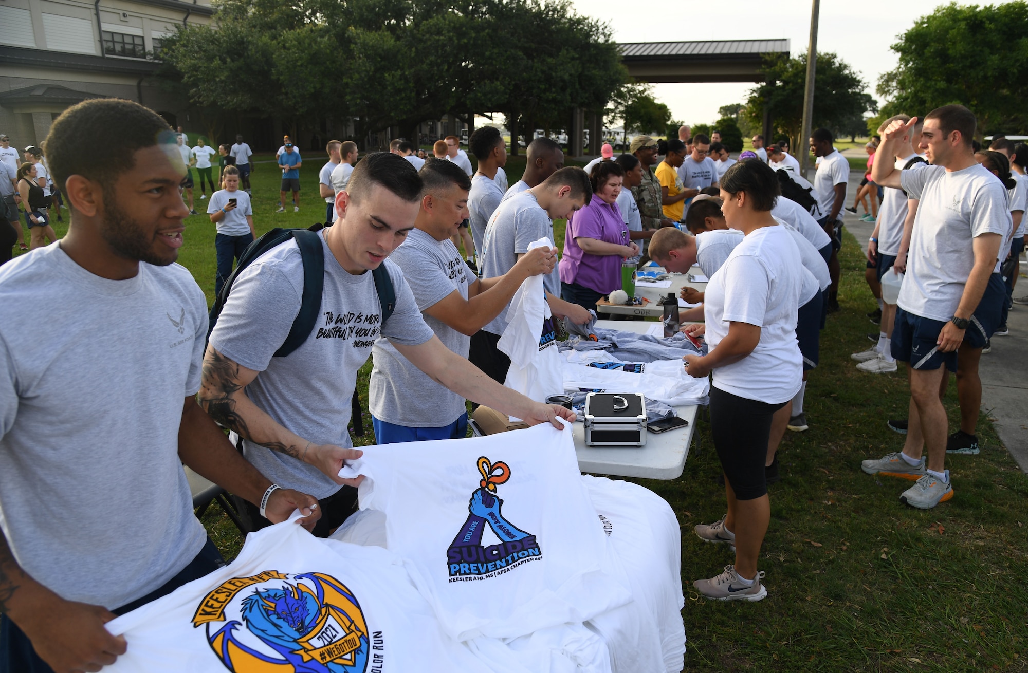 Keesler personnel sign up to participate in the Suicide Prevention Color Run at marina park at Keesler Air Force Base, Mississippi, June 16, 2022. More than 250 runners and 70 volunteers participated in the Air Force Sergeants Association Chapter 652 hosted event. (U.S. Air Force photo by Kemberly Groue)