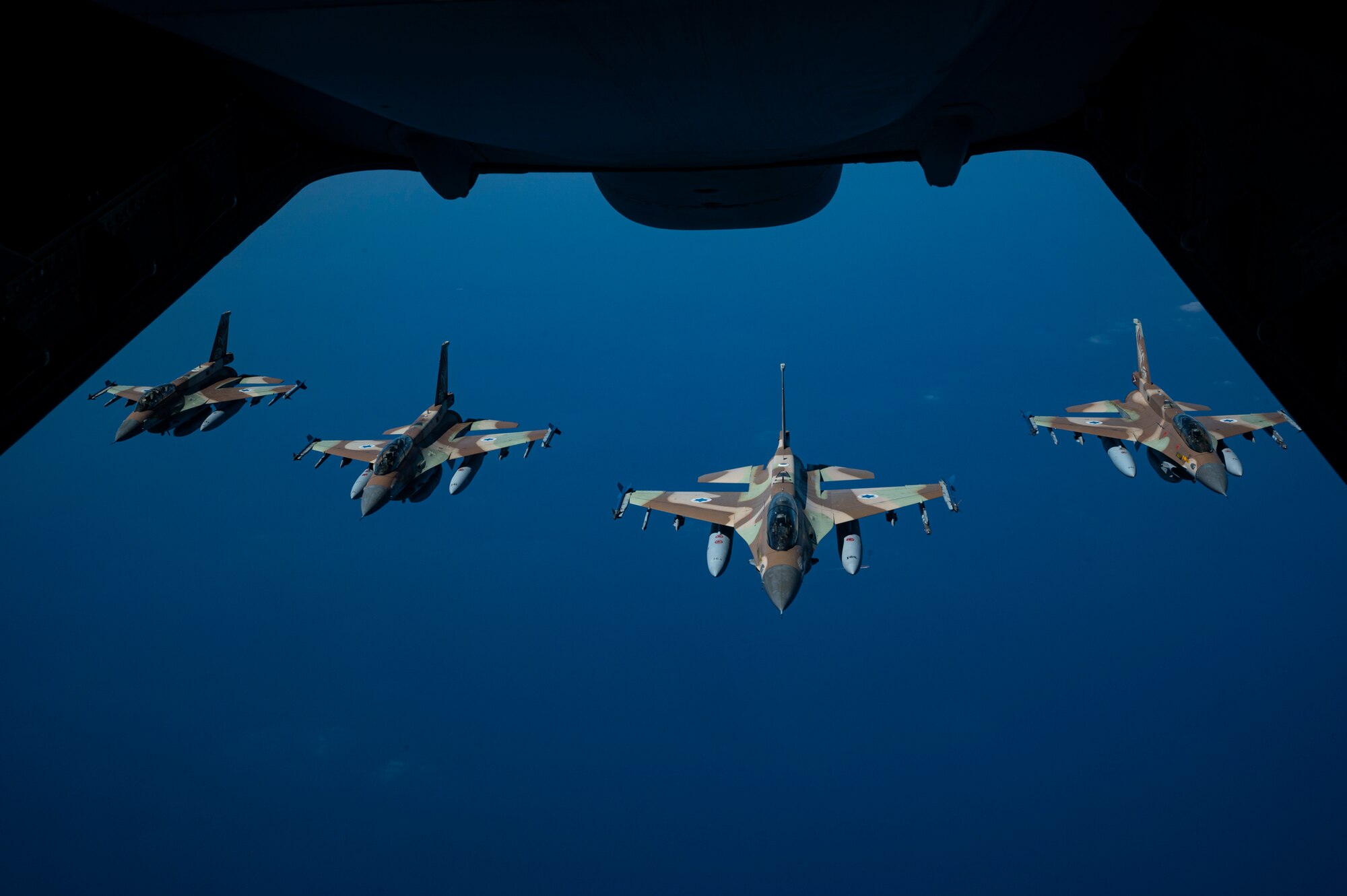 Israeli Defense Forces F-16 Barak aircraft fly in a formation after a successful refueling with a U.S. Air Force KC-10 Extender assigned to the 908th Expeditionary Air Refueling Squadron, within the Ninth Air Force (Air Forces Central) area of responsibility, May 18, 2022.