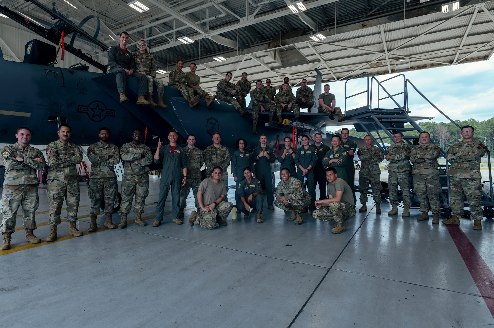 Airmen assigned to the 4th Fighter Wing and students from the First Term Officer Course pose for a photo with an F-15E Strike Eagle after a tour at Seymour Johnson Air Force Base, North Carolina, June 9, 2022. A base tour concluded the two-day long FTOC. (U.S. Air Force photo by Senior Airman Kevin Holloway)