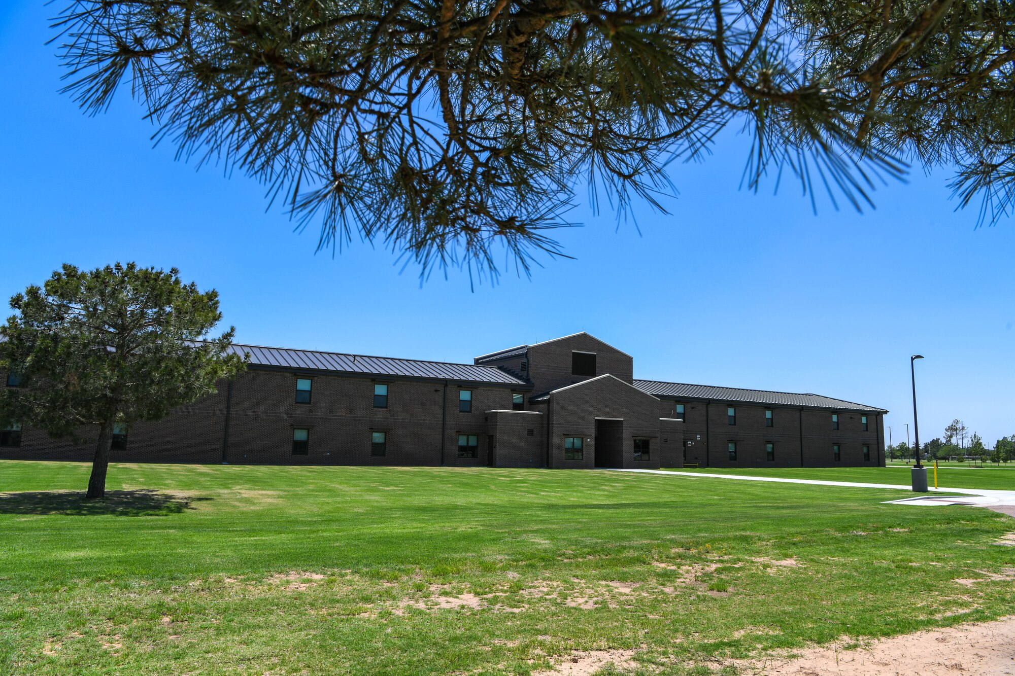 The newest dormitory stands at Altus Air Force Base, Oklahoma, June 13, 2022. The layout for the dorm is based on the “Dorms for Airmen” concept and features a suite-style layout. (U.S. Air Force photo by Airman 1st Class Trenton Jancze)