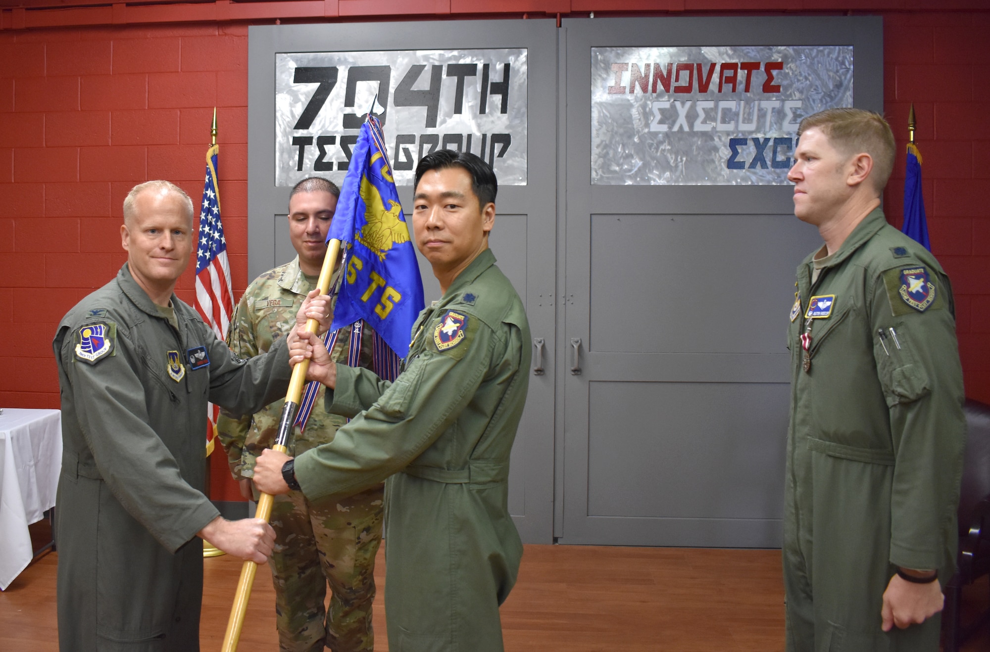 Col. Darren Wees, left, 704th Test Group Commander, hands the guidon to Lt. Col. Brian Davis charging him with command of the 746th Test Squadron during a Change of Command Ceremony at Holloman Air Force Base, New Mexico, June 8, 2022.