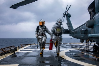Fireman Dustin Groot, from Winchester, Mass., left, and Damage Controlman 3rd Class William Jackson, from Mt. Vernon, Va., step in sync on the flight deck of the Ticonderoga-class guided-missile cruiser USS Chancellorsville (CG 62) during a crash and salvage drill.