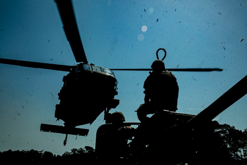 U.S. Army Soldiers with the 4th Battalion, 3rd Aviation Brigade, and the Bravo Battery, 1st Battalion, 118th Field Artillery Regiment, conduct sling-load operations at Fort Stewart, Ga., June 14, 2022. The XCTC exercise included approximately 4,400 brigade personnel from throughout Georgia.