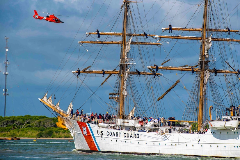 A helicopter flies over a ship.