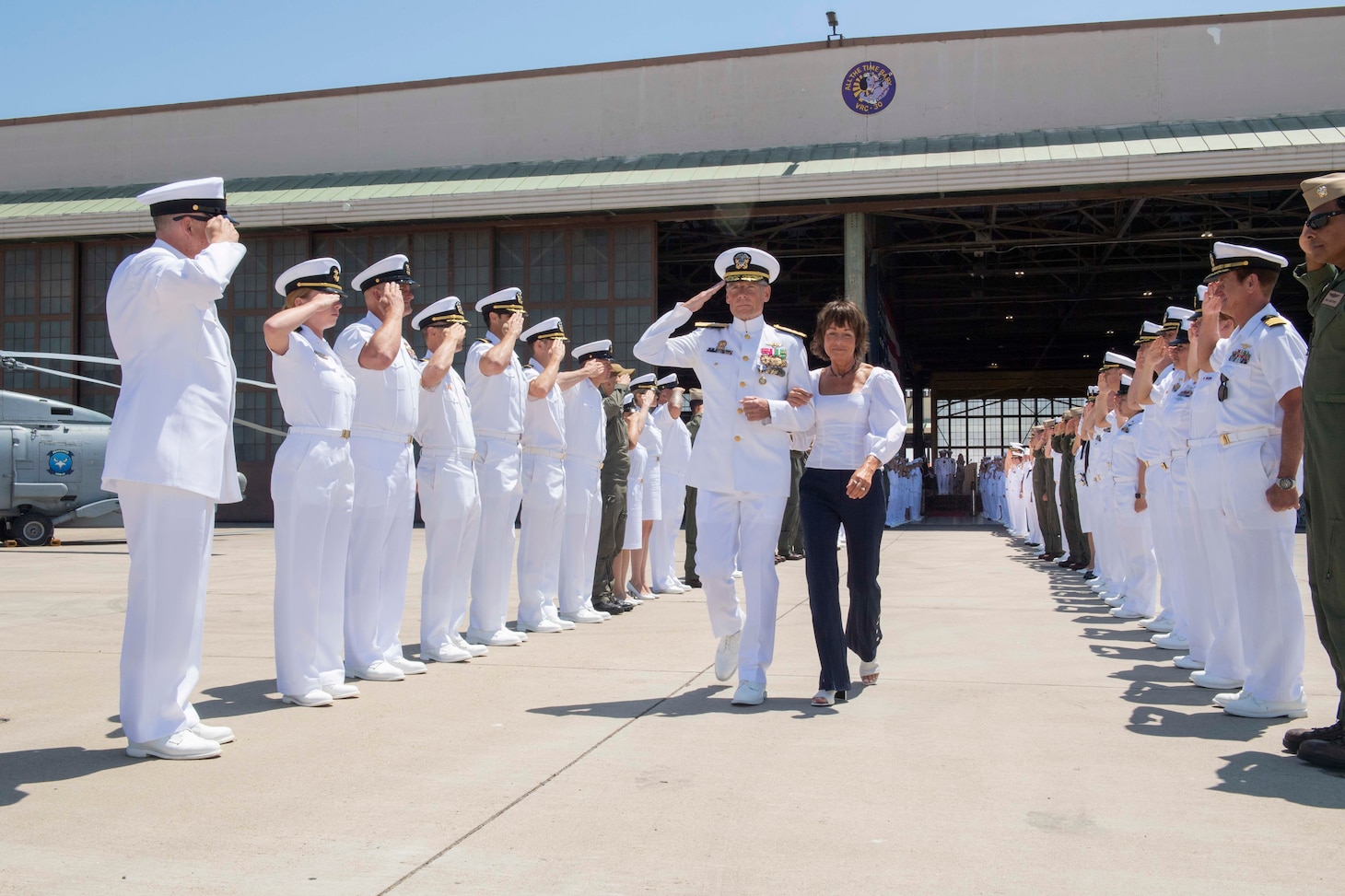 Rear Adm. Scott Jones and his wife Teresa Rider-Jones depart through the side boys