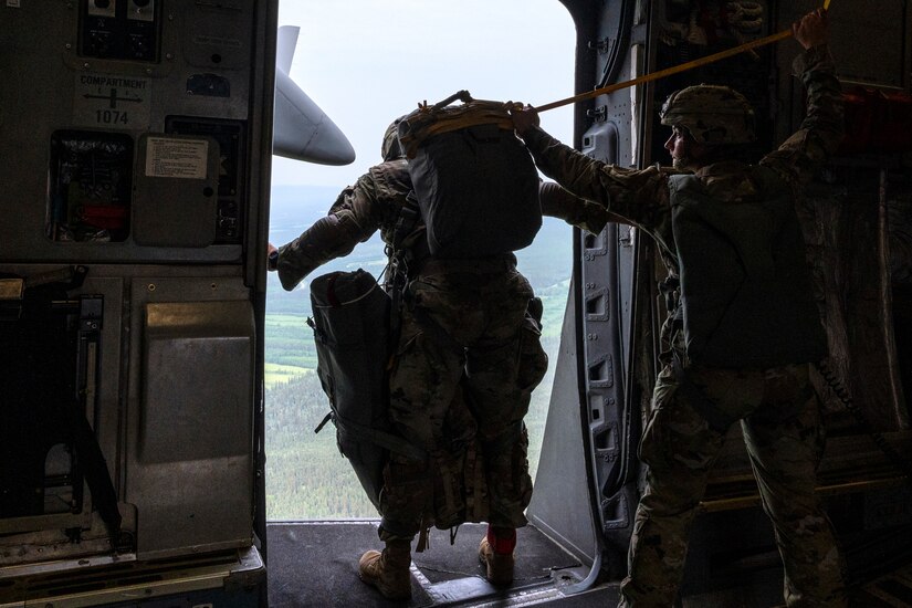 U.S. Army Sgt. 1st Class Charlie Arrendale, looks out the door as they prepare to jump from a C-17 Globemaster III from the 517th Airlift Squadron over Allen Army Airfield, Fort Greely, Alaska, June 15, 2022. RF-A provides realistic combat training by integrating joint, coalition and multilateral forces into simulated forward operating bases. Arrendale is assigned to the 3rd Battalion, 509th Infantry Regiment, 2nd Infantry Brigade Combat Team (Airborne), 11th Airborne Division. (U.S. Air Force photo by Sheila deVera)