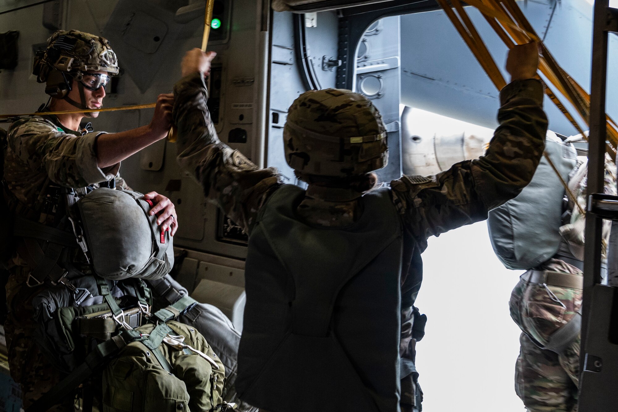 U.S. Army Paratroopers jump out of a C-17 Globemaster III from the 517th Airlift Squadron, Joint Base Elmendorf-Richardson, Alaska over Allen Army Airfield, Fort Greely, June 15, 2022. RF-A provides realistic combat training by integrating joint, coalition and multilateral forces into simulated forward operating bases. (U.S. Air Force phot by Sheila deVera)