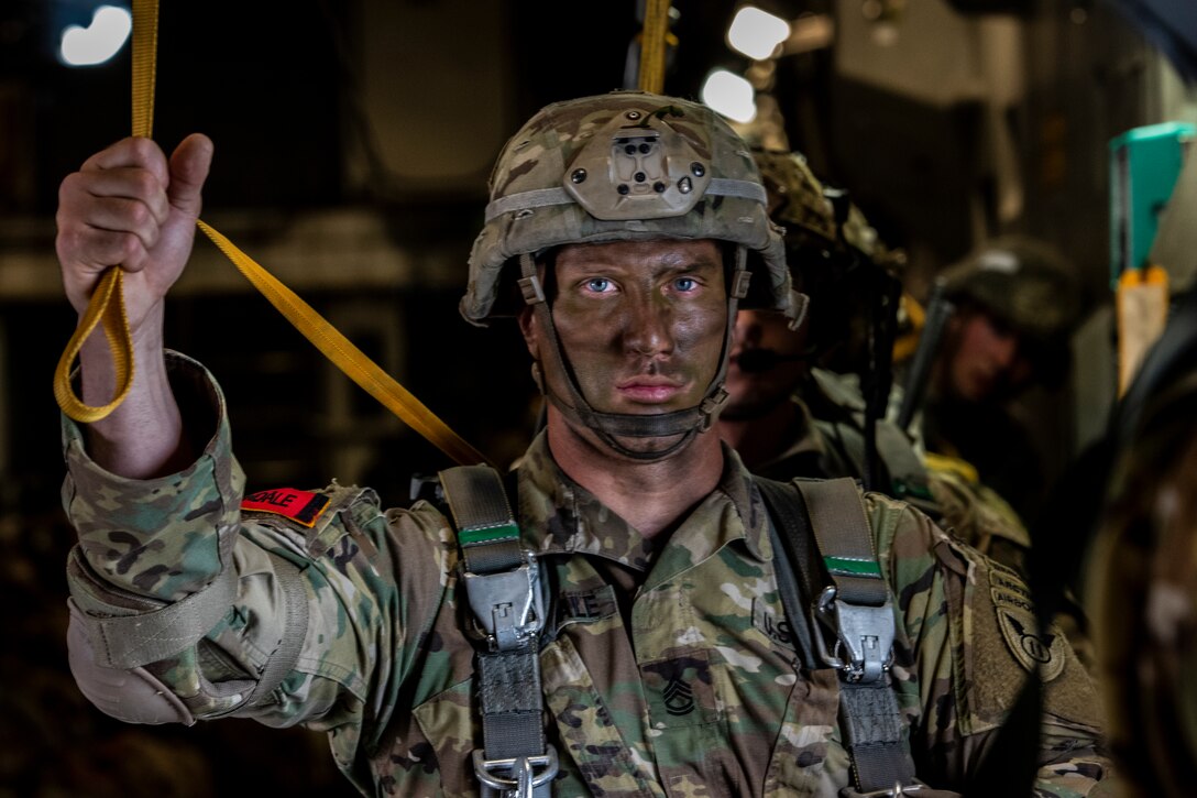 U.S. Army Sgt. 1st Class Charlie Arrendale holds his static-line in the “stand-by” position as he prepares to jump from a C-17 Globemaster III from the 517th Airlift Squadron over Allen Army Airfield, Fort Greely, Alaska, June 15, 2022. RF-A provides realistic combat training by integrating joint, coalition and multilateral forces into simulated forward operating bases. Arrendale is assigned to the 3rd Battalion, 509th Infantry Regiment, 2nd Infantry Brigade Combat Team (Airborne), 11th Airborne Division. (U.S. Air Force photo by Sheila deVera)