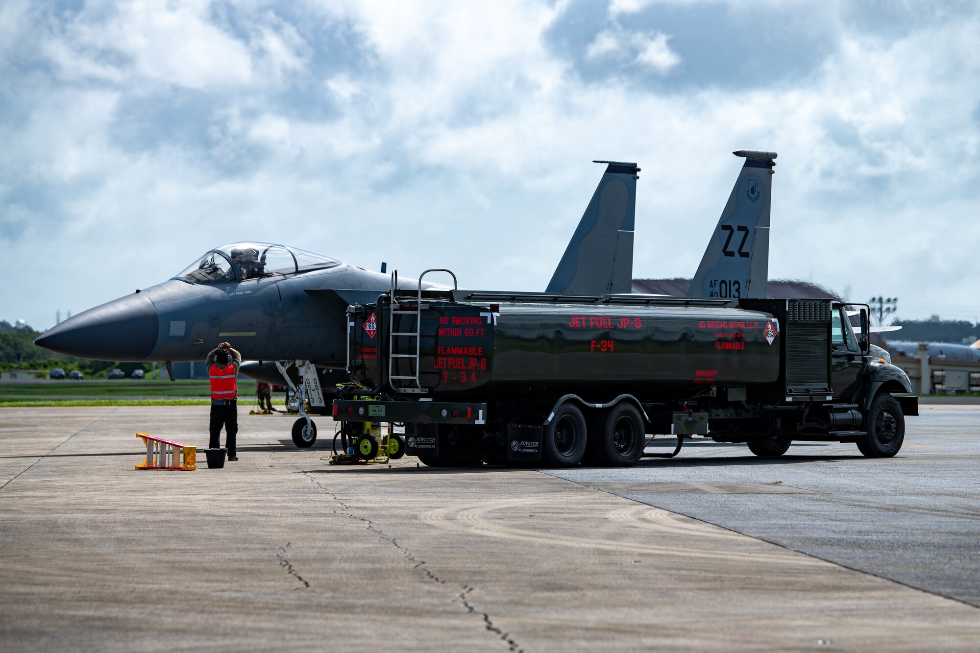 An Airman directs a jet for refueling.