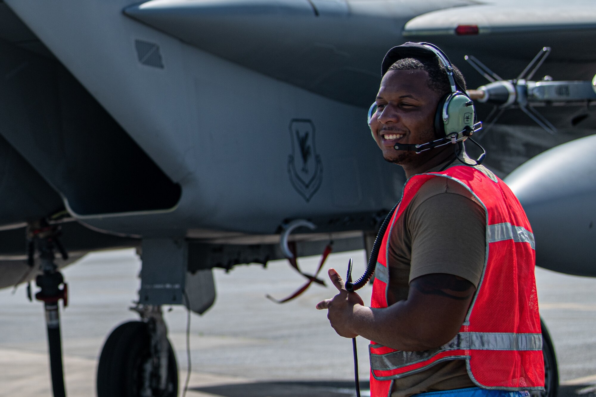 An Airman directs a jet.