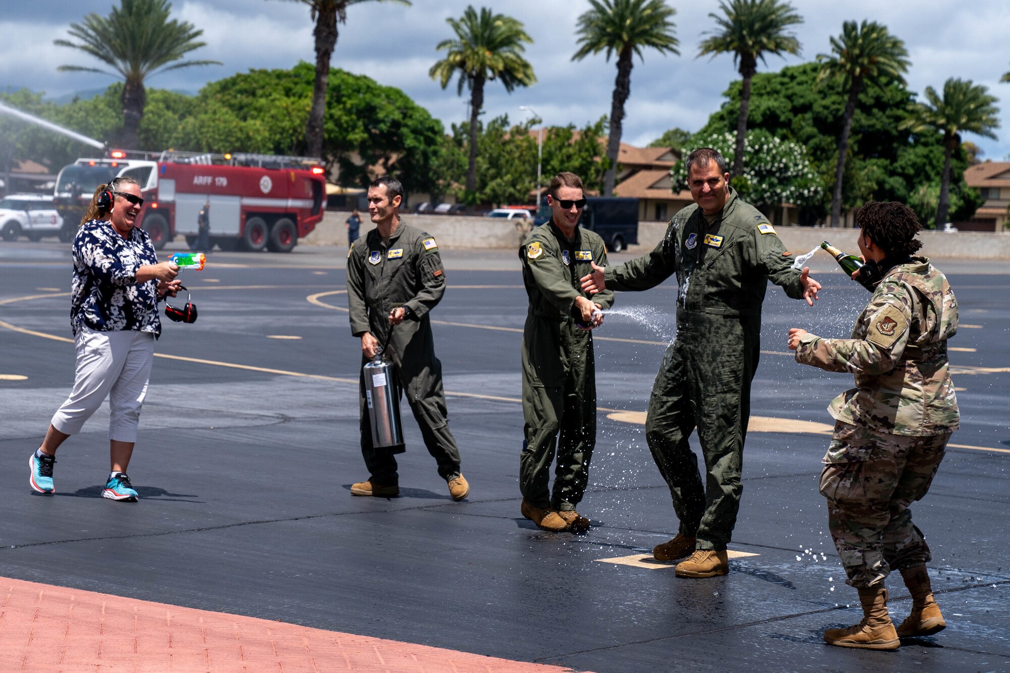 Col. Daniel Dobbels, 15th Wing commander, celebrates with his family and team members after flying his final flight on a C-17 Globemaster III at Joint Base Pearl Harbor-Hickam, Hawaii, June 15, 2022. Dobbels is retiring after 24 years of active duty service and more than 3,200 hours as a command pilot of the C-17, C-12, T-1, and T-37 aircraft. (U.S. Air Force photo by Airman 1st Class Makensie Cooper)