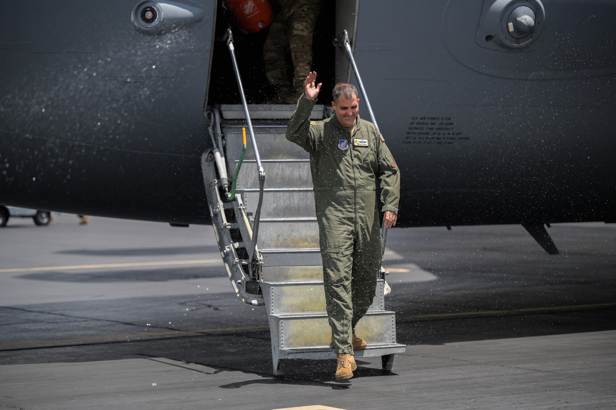 Col. Daniel Dobbels, 15th Wing commander, steps off a C-17 Globemaster III after conducting his final flight at Joint Base Pearl Harbor-Hickam, Hawaii, June 15, 2022. Dobbels is scheduled to relinquish command on July 8, 2022, after serving as the senior airfield authority on Hickam Field for two years. (U.S. Air Force photo by Staff Sgt. Alan Ricker)