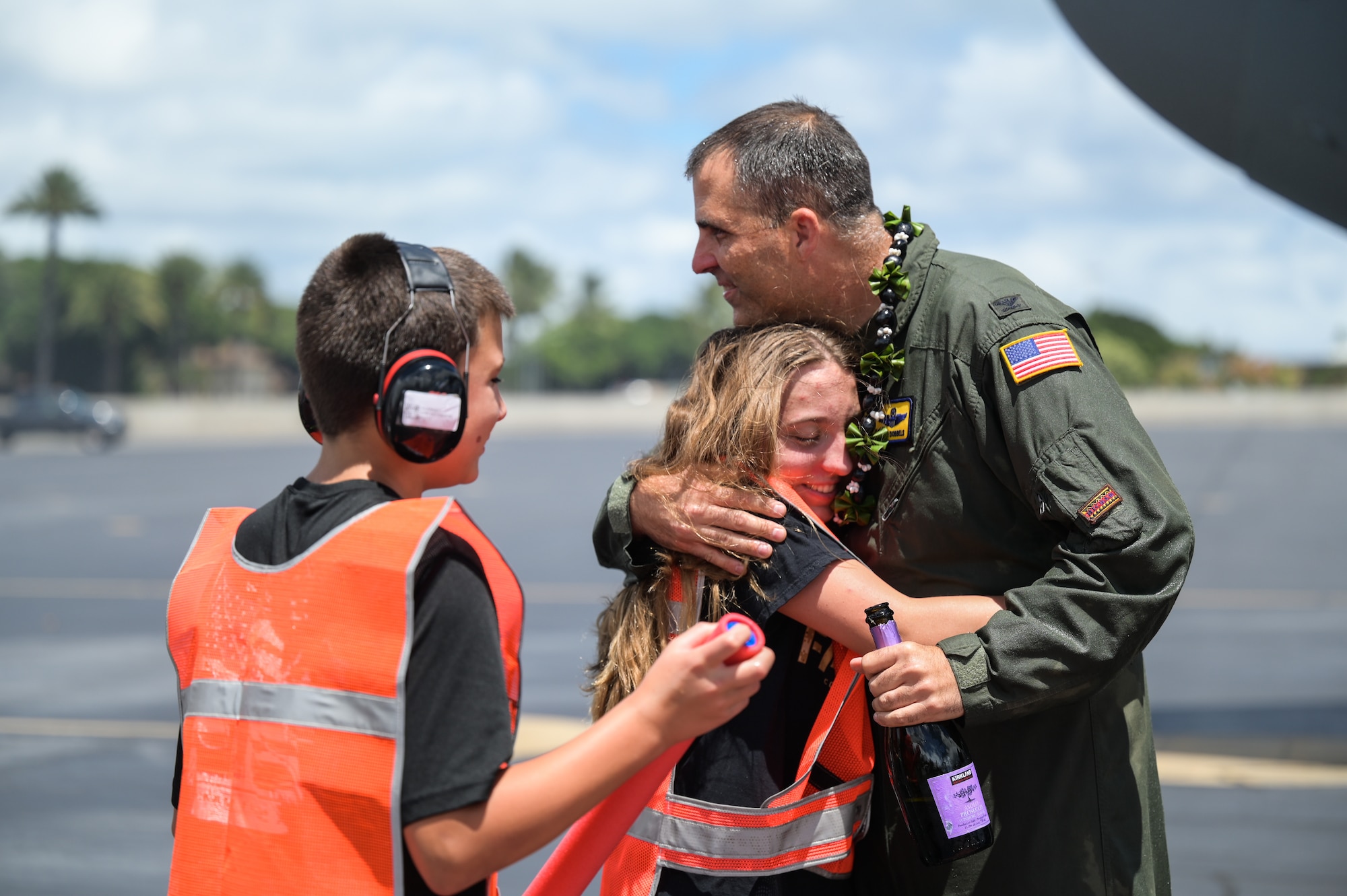 Col. Daniel Dobbels, 15th Wing commander, celebrates with his family after flying his final flight on a C-17 Globemaster III at Joint Base Pearl Harbor-Hickam, Hawaii, June 15, 2022. The fini-flight began as an aviator’s tradition in World War II, signifying a pilot’s retirement, departure, or final flight of a specified aircraft. (U.S. Air Force photo by Staff Sgt. Alan Ricker)