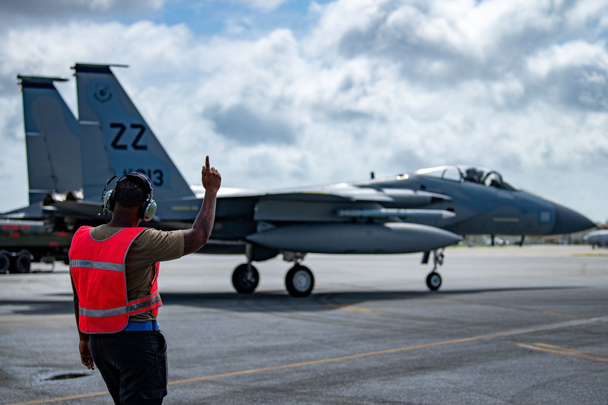 An Airman directs a jet.