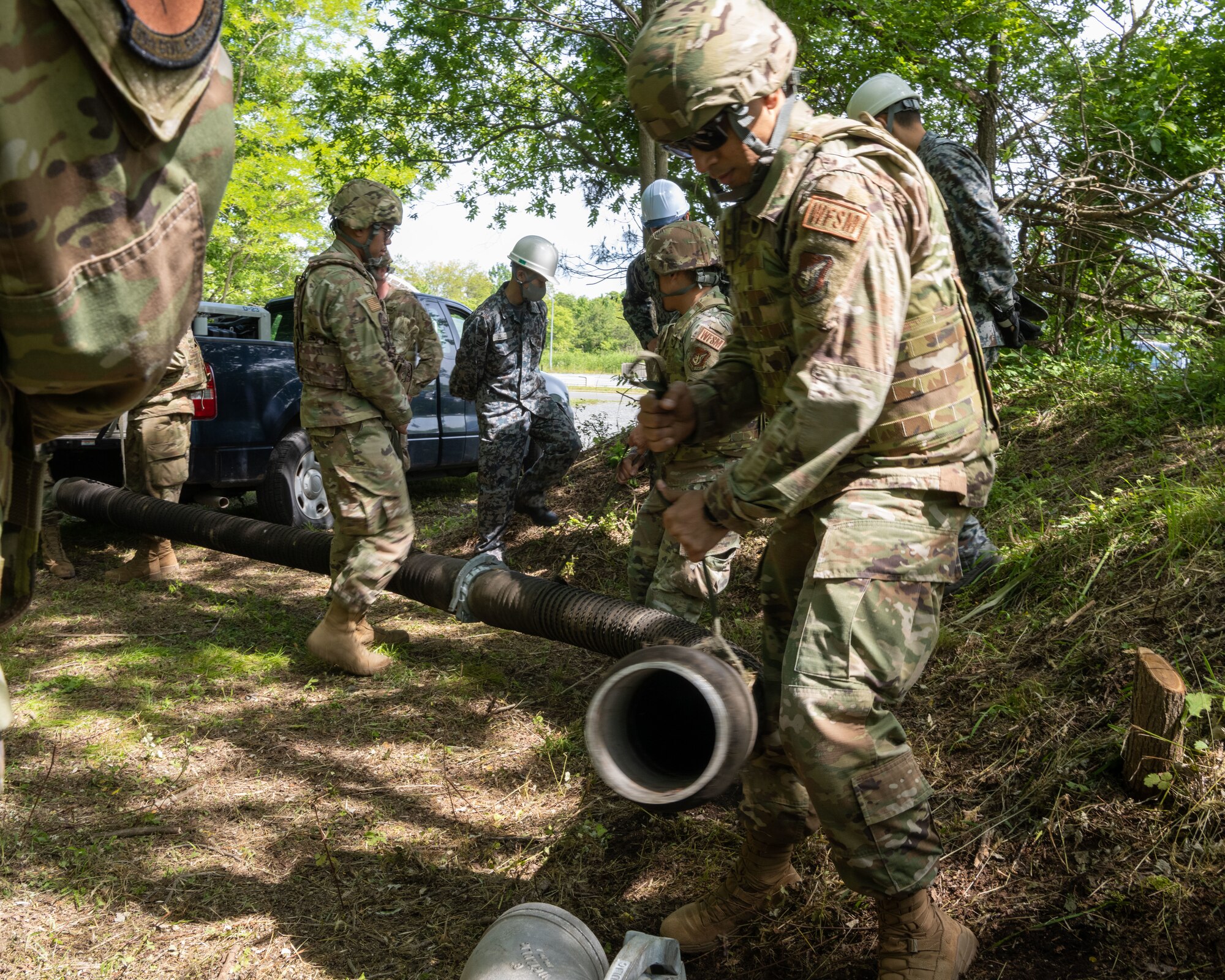 U.S. Air Force Tech. Sgt. Jaime, 35th Civil Engineer Squadron water and fuel system craftsman, moves the new pipe for setup as part of the Water and Fuel Expedient Repair System (WaFERS) training during an annual Prime Base Engineer Emergency Force (Prime BEEF) training at Misawa Air Base, Japan, June 14, 2022.