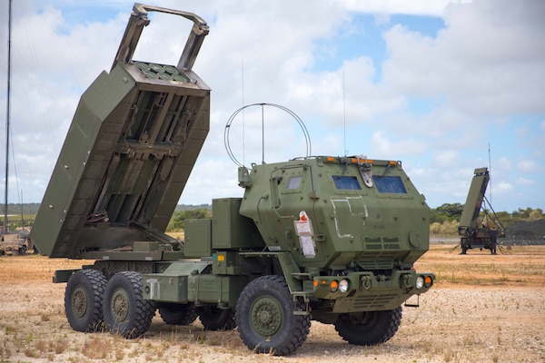 U.S. Marines with 5th Battalion, 11th Marine Regiment set up an M142 High Mobility Artillery Rocket System in front of an AN/TPS-80 Ground/Air Task Oriented Radar with Marine Air Control Group (MACG) 18 at Andersen Air Force Base, Guam, June 13, 2022, in support of Valiant Shield 2022. Exercise Valiant Shield gives units like MACG-18 the opportunity to integrate with forces across the Indo-Pacific to train in successful employment and operations that demonstrate the strength and versatility of the Joint Force. (U.S. Marine Corps photo by Cpl. Tyler Harmon)