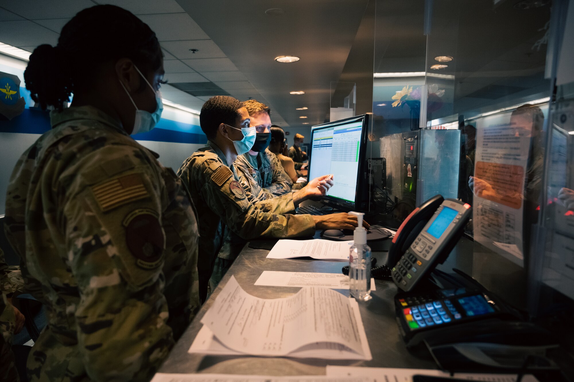 Airmen overlook a computer for passenger processing