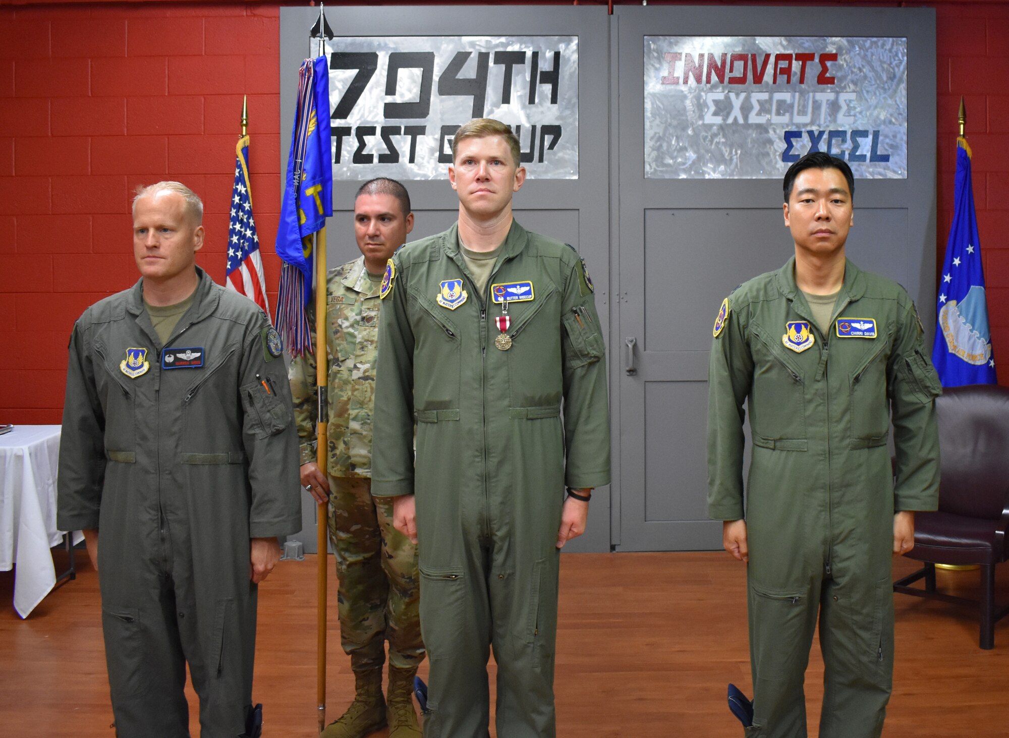 Col. Darren Wees, commander of the 746th Test Squadron, 704th Test Group, Arnold Engineering Development Complex, Lt. Col. John Wisecup and Lt. Col. Brian Davis participate in a Change of Command Ceremony at Holloman Air Force Base, New Mexico, June 8, 2022.