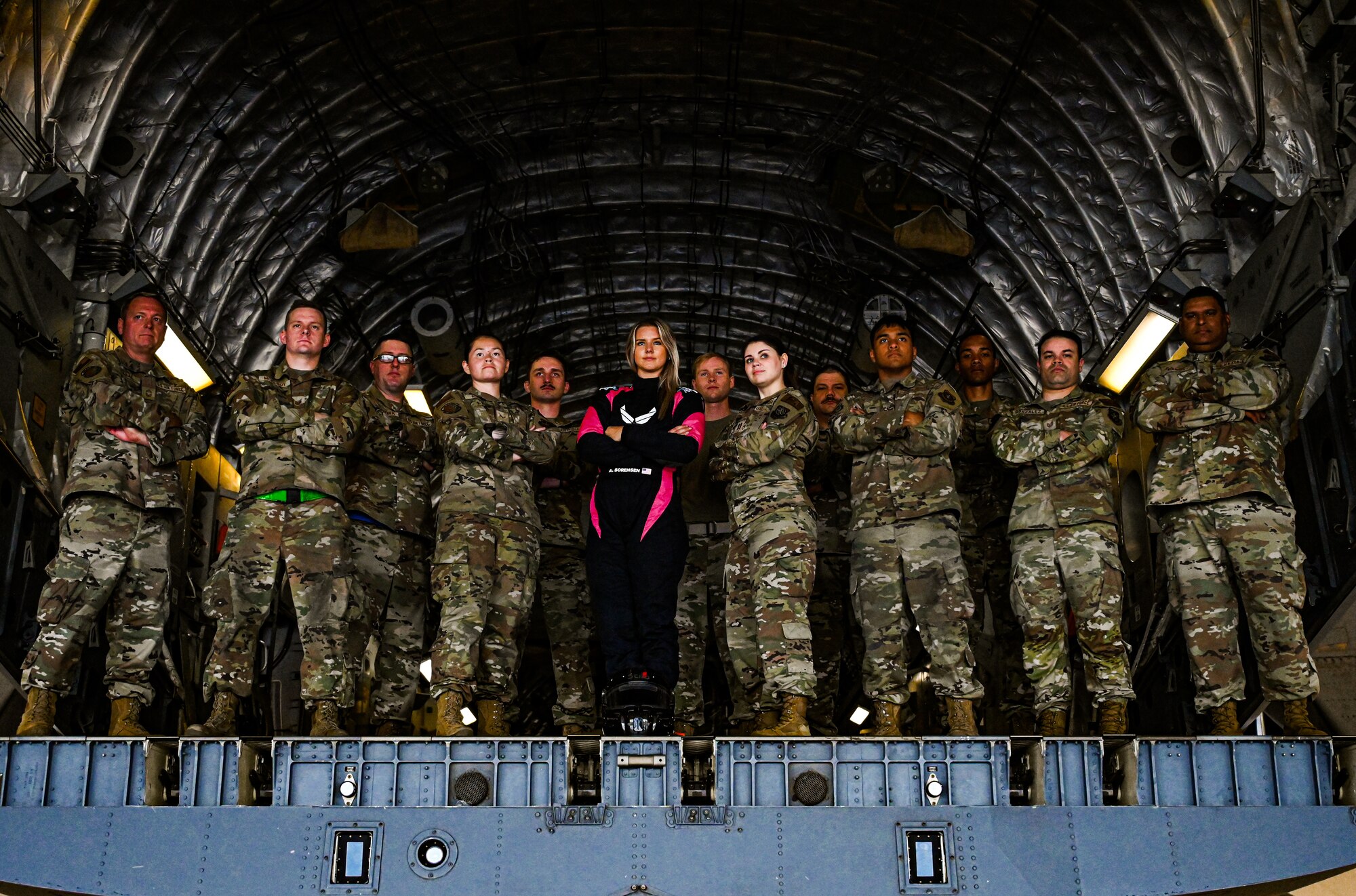 Airmen from the 305th Air Mobility Wing pose with Formula Drift driver Amanda Sorenson on the ramp of a C-17 Globemaster III at Joint Base McGuire-Dix-Lakehurst on June 7, 2022. Drift team duo Branden and Amanda Sorensen visited JB MDL to interact with Airmen and learn about different Air Force career fields. Air Force Recruiting Service recently continued their 13-year partnership with the Formula Drift series. Throughout the 2022 Formula Drift circuit, the Air Force will serve as the primary sponsor for the Sorensen Motorsports team.